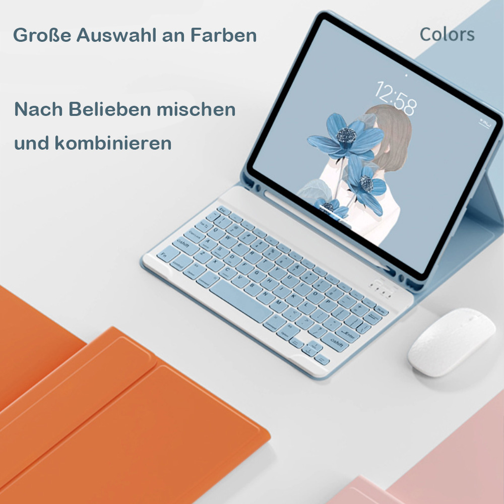 Ein Tablet mit Tastatur und Maus, daneben bunte Hüllen.