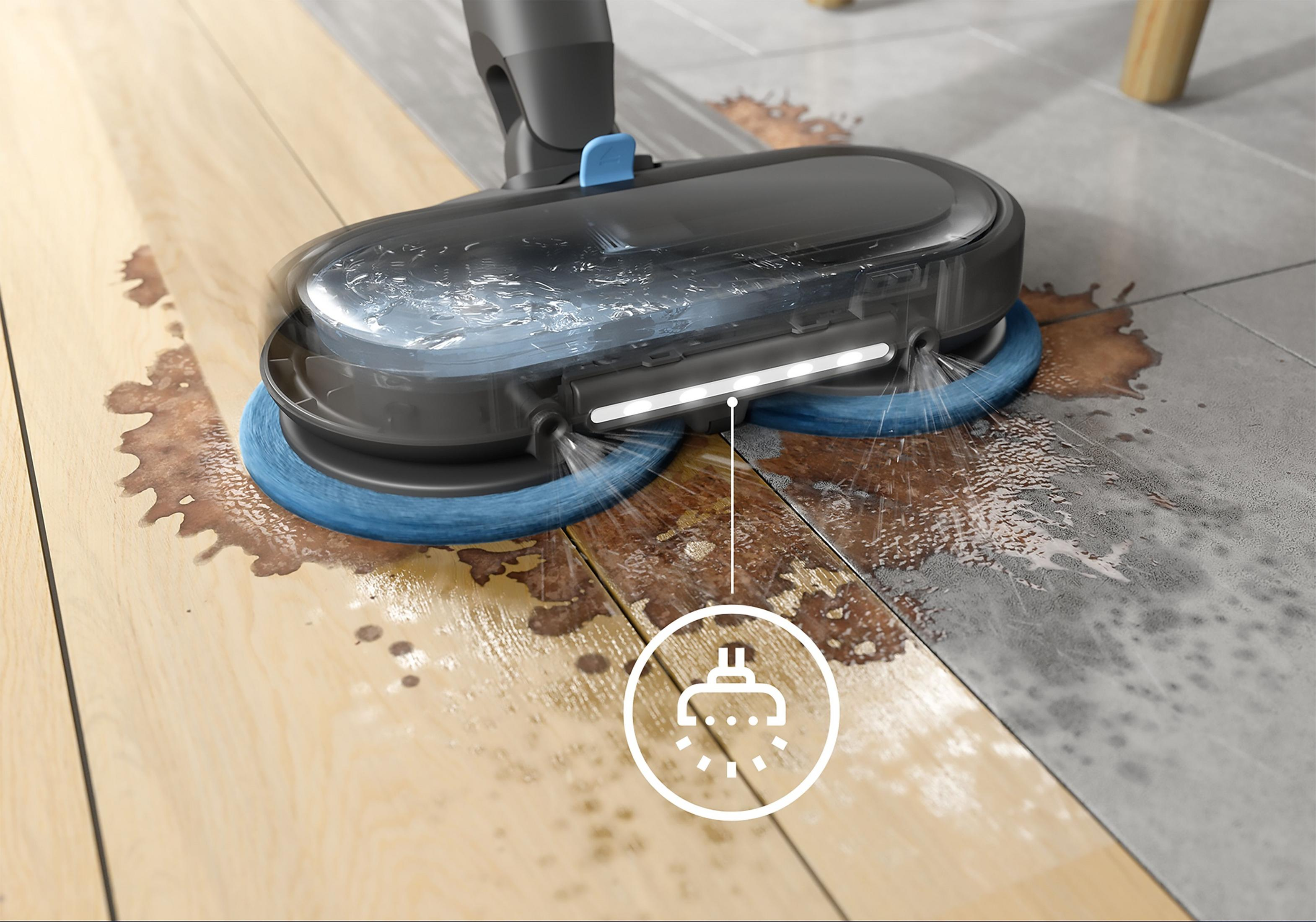 Un nettoyeur humide avec brosses rotatives nettoie un parquet et des carrelages sales.