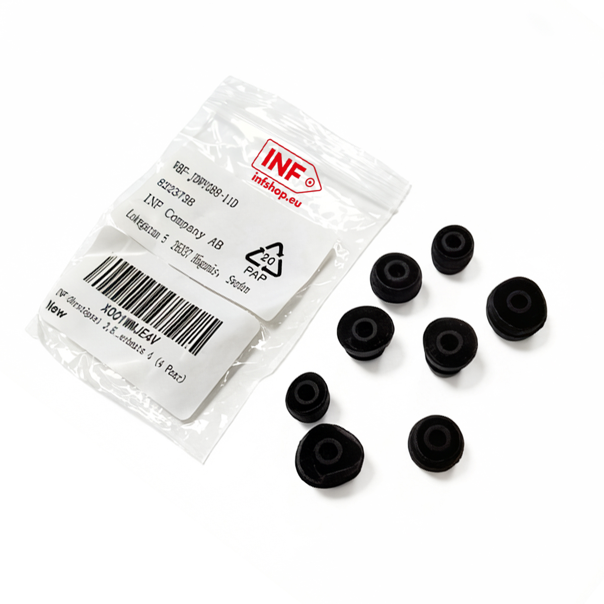 Schwarze Gummipuffer liegen neben einer INF-Verpackung auf weißem Hintergrund.