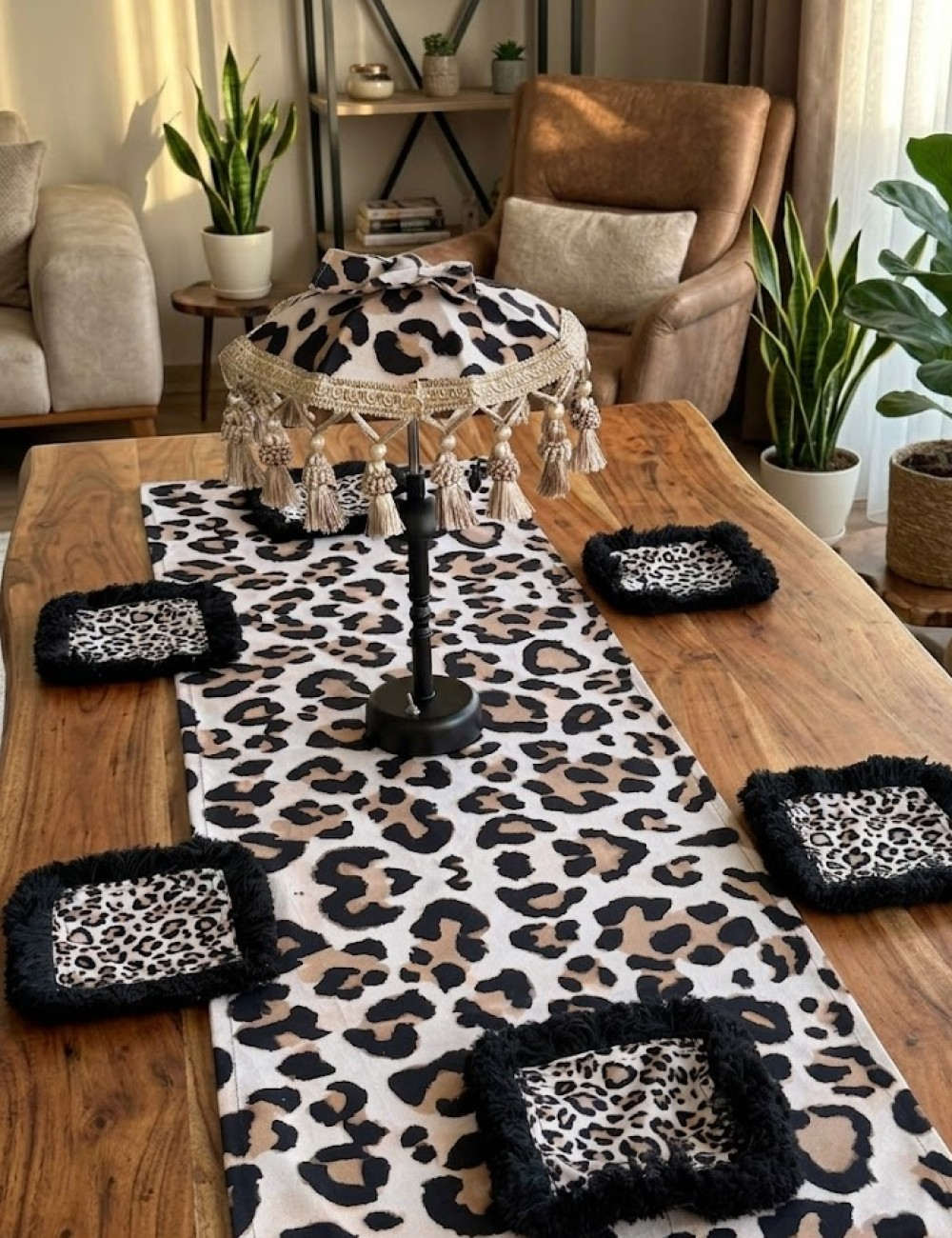 Ahşap bir masa üzerinde leopar desenli masa örtüsü ve bardak altlıkları.
