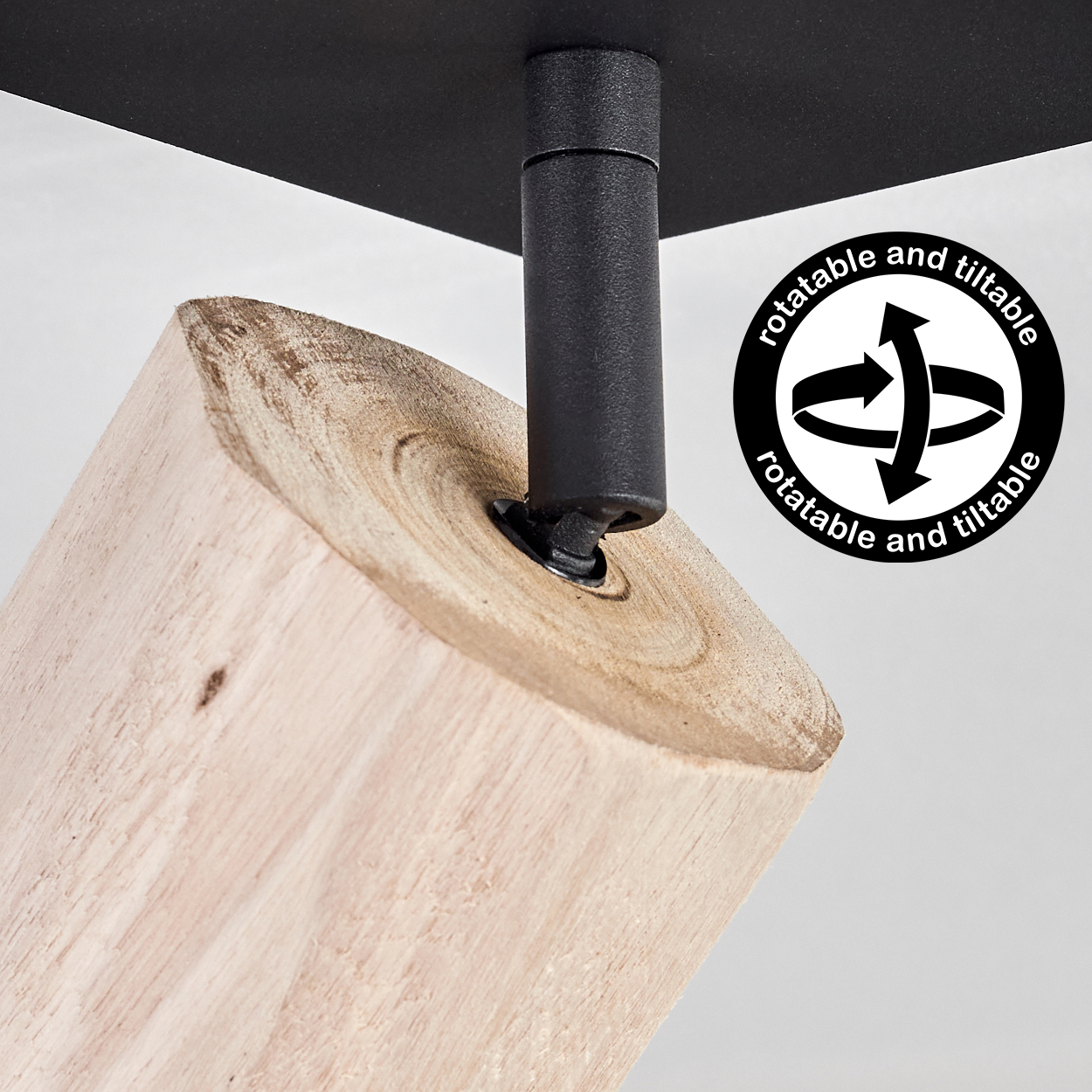 Ein Holzwürfel mit schwarzer Halterung und einem Drehsymbol.