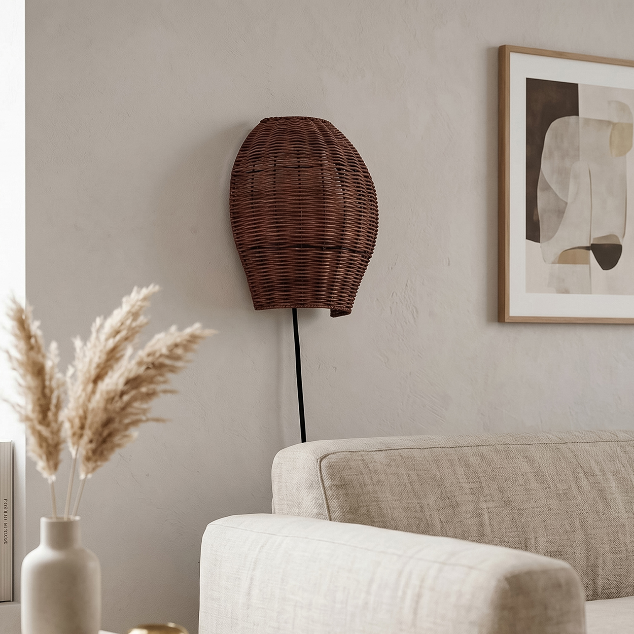 Braunes Weidenkorb-Wandlicht neben einem Sofa und einem Bild mit abstrakter Kunst.