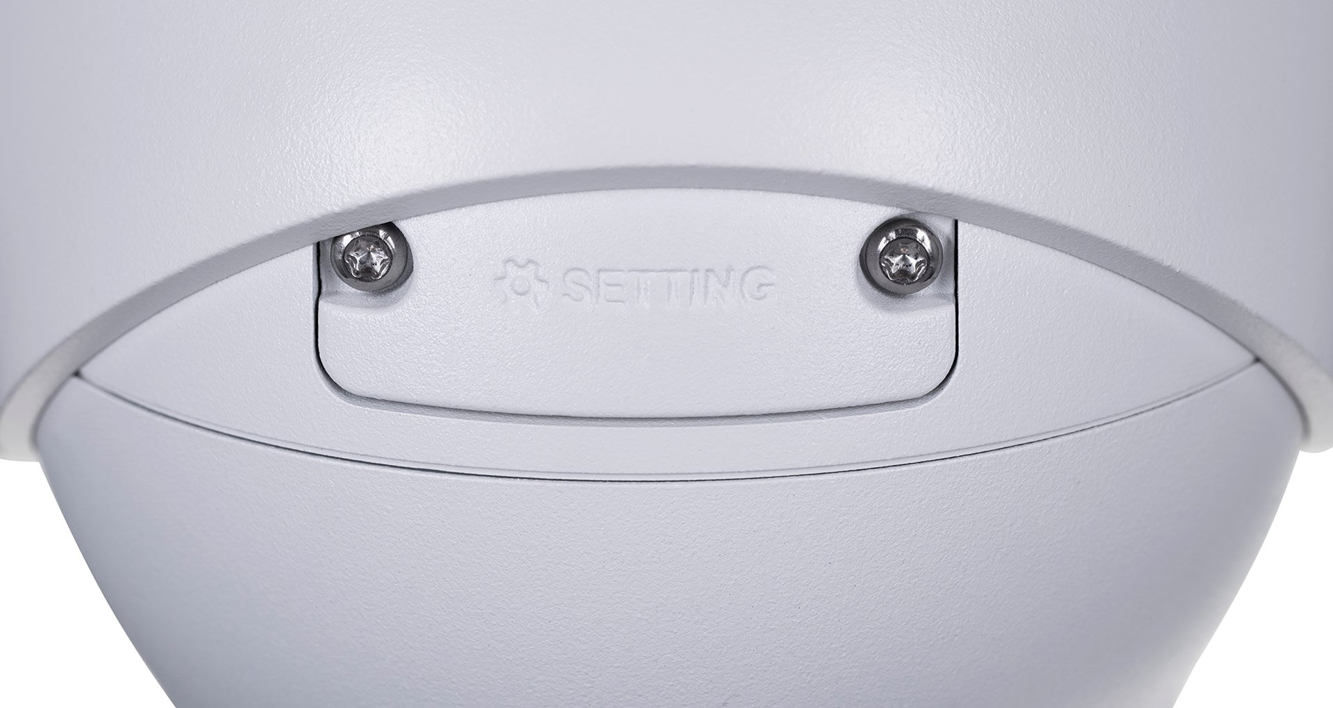 Close-up of a white camera surface with the word "SETTING" and two screws.