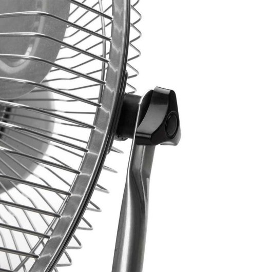 Primo piano di una griglia metallica per ventilatore con manopola di regolazione nera.