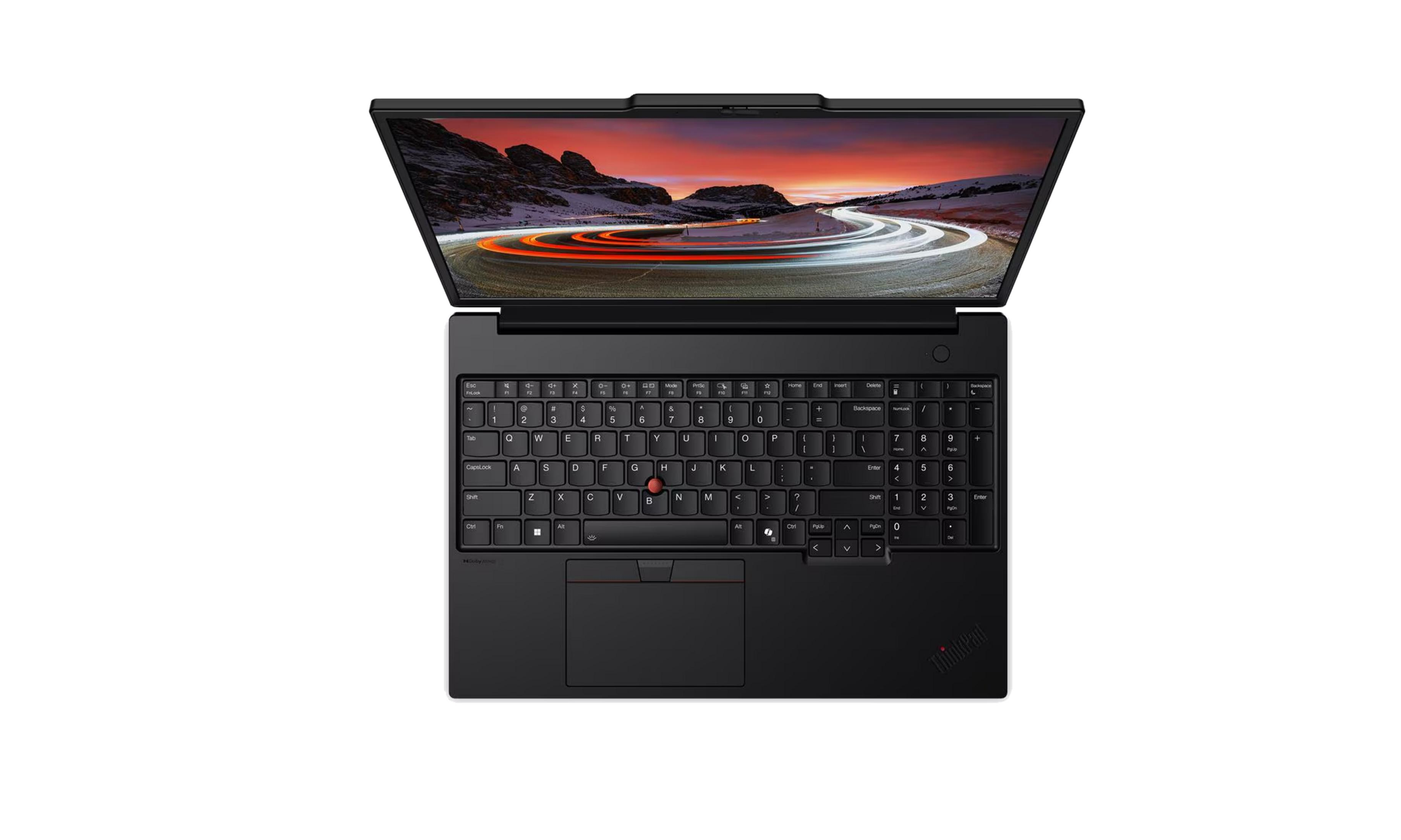 Laptop nero con schermo che mostra una strada panoramica al tramonto. Tastiera e trackpad visibili.