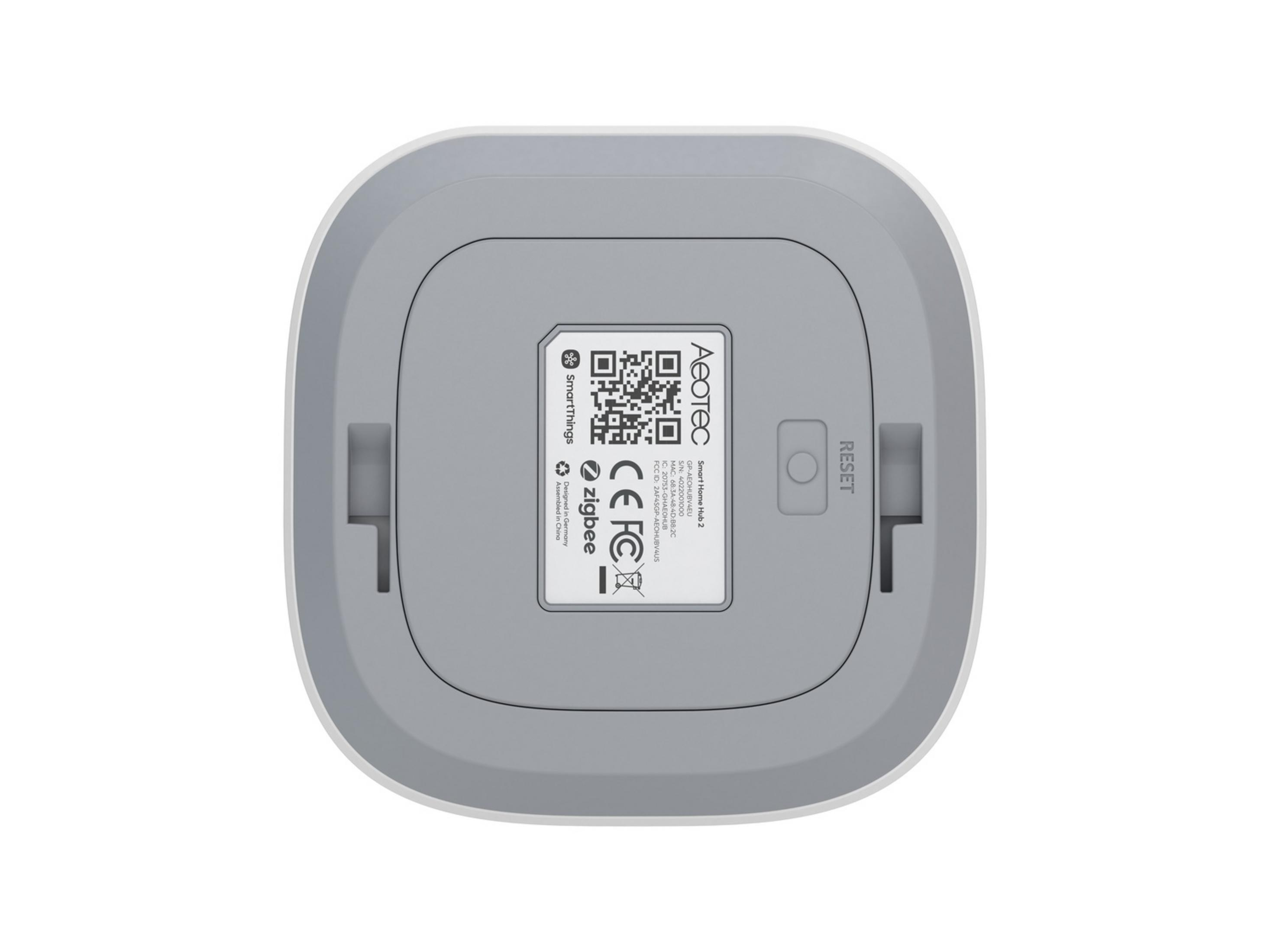 Rückseite eines weißen und grauen Smart Home Hubs mit Etikett.