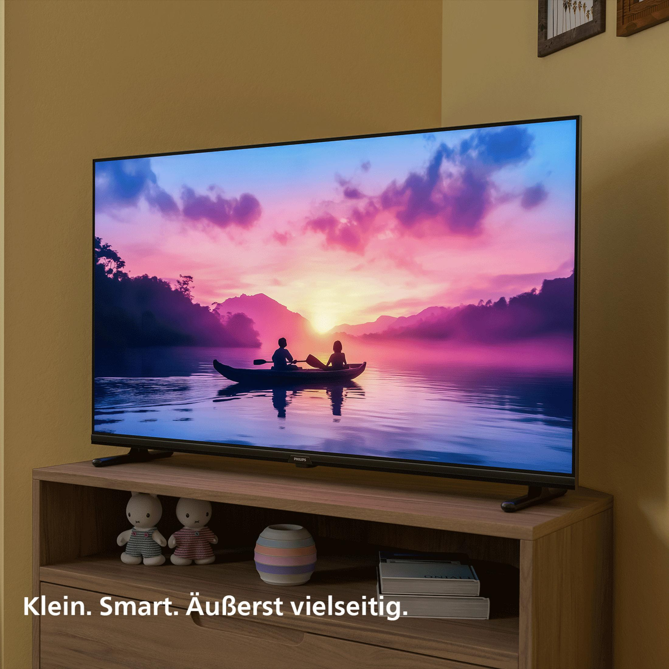 Telewizor pokazuje zachód słońca nad jeziorem z dwiema osobami w kajaku.