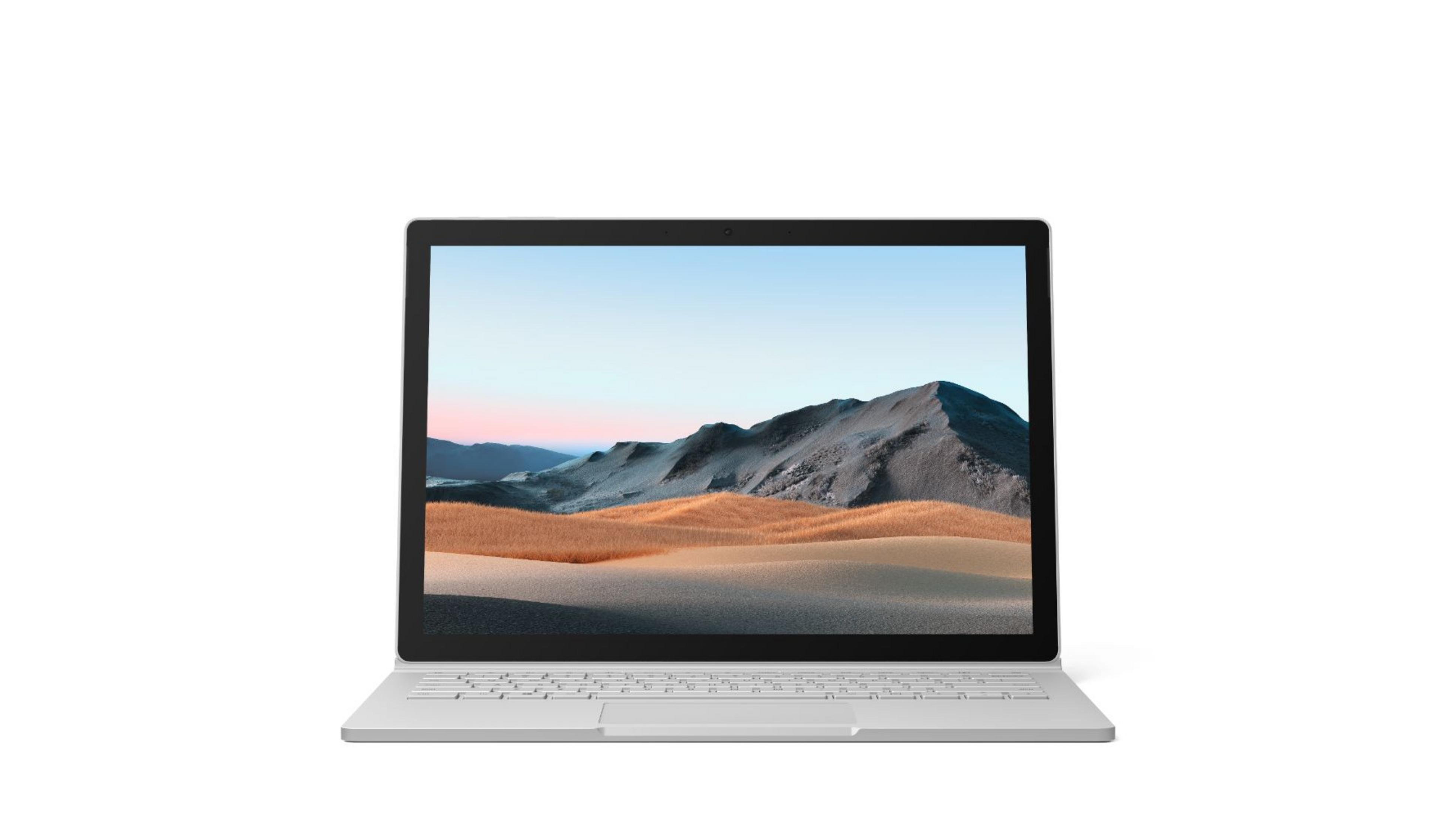 Un portátil gris claro que muestra una imagen de paisaje en su pantalla.