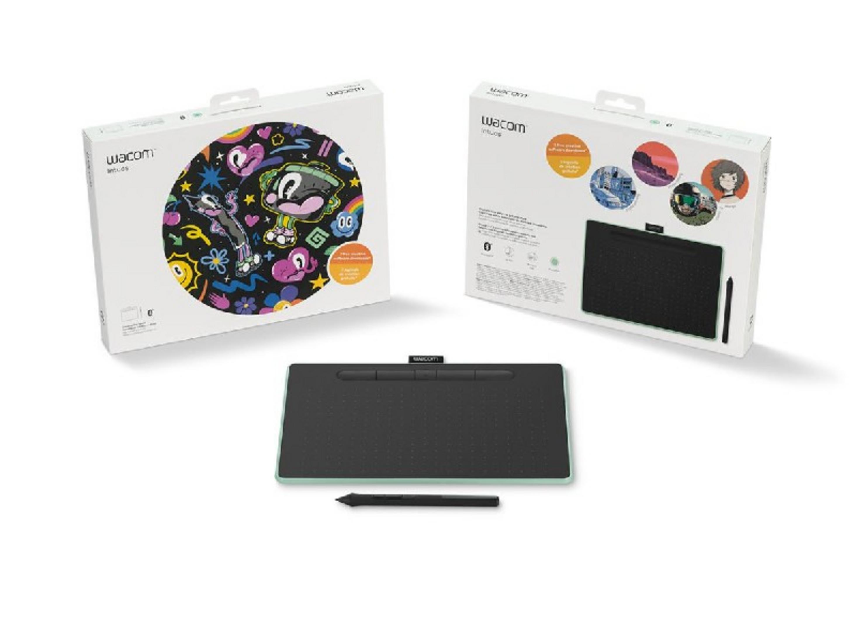 Una tableta gráfica negra con un lápiz y dos cajas Wacom.