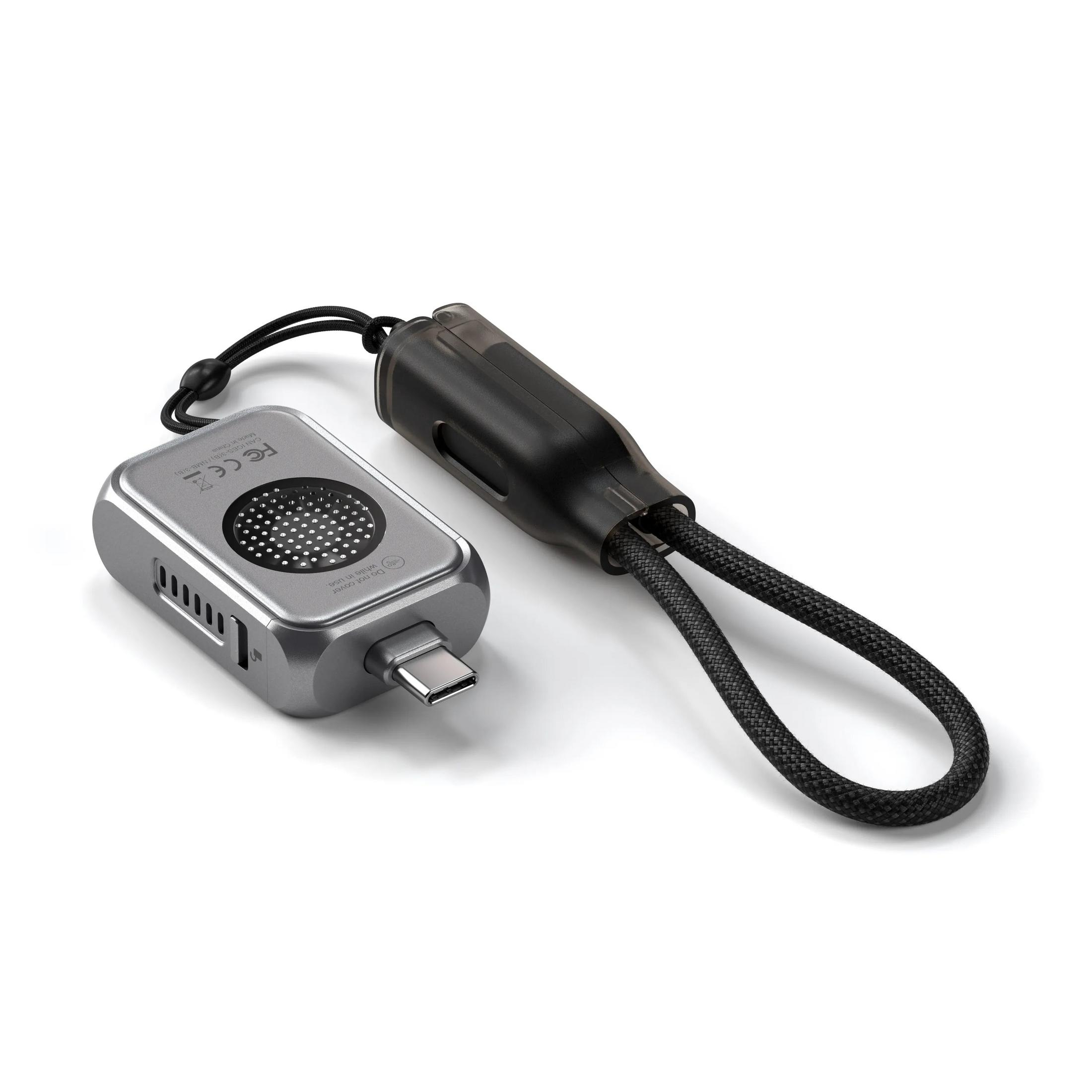 Un adaptateur USB-C argenté avec un câble noir et un connecteur transparent.