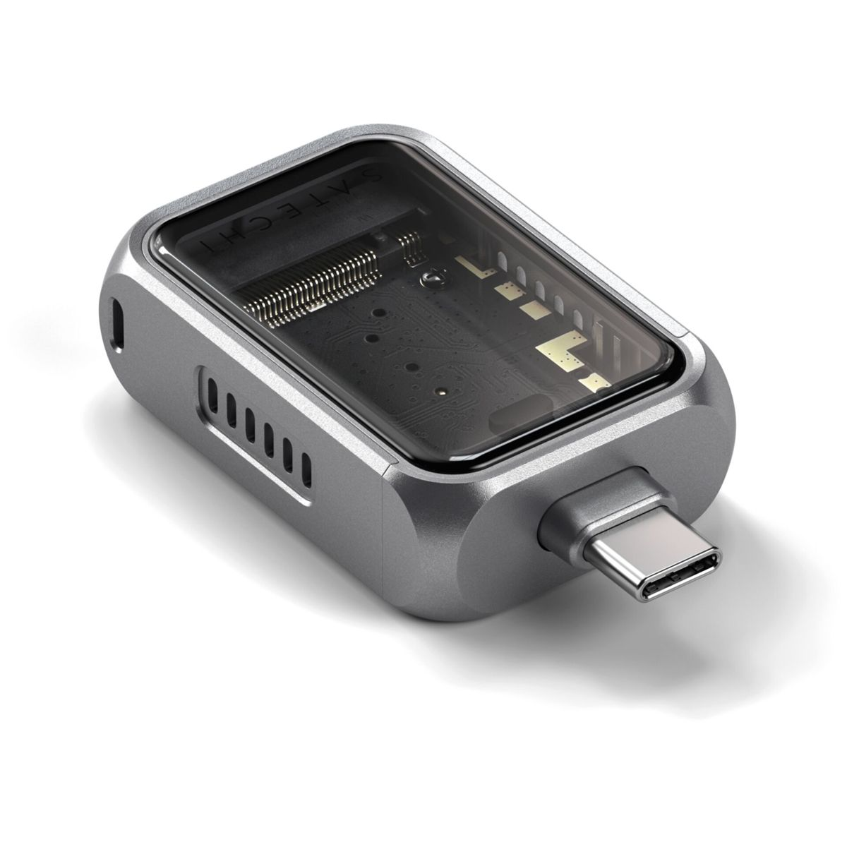Un adaptateur USB-C argenté avec boîtier transparent révélant le circuit interne.