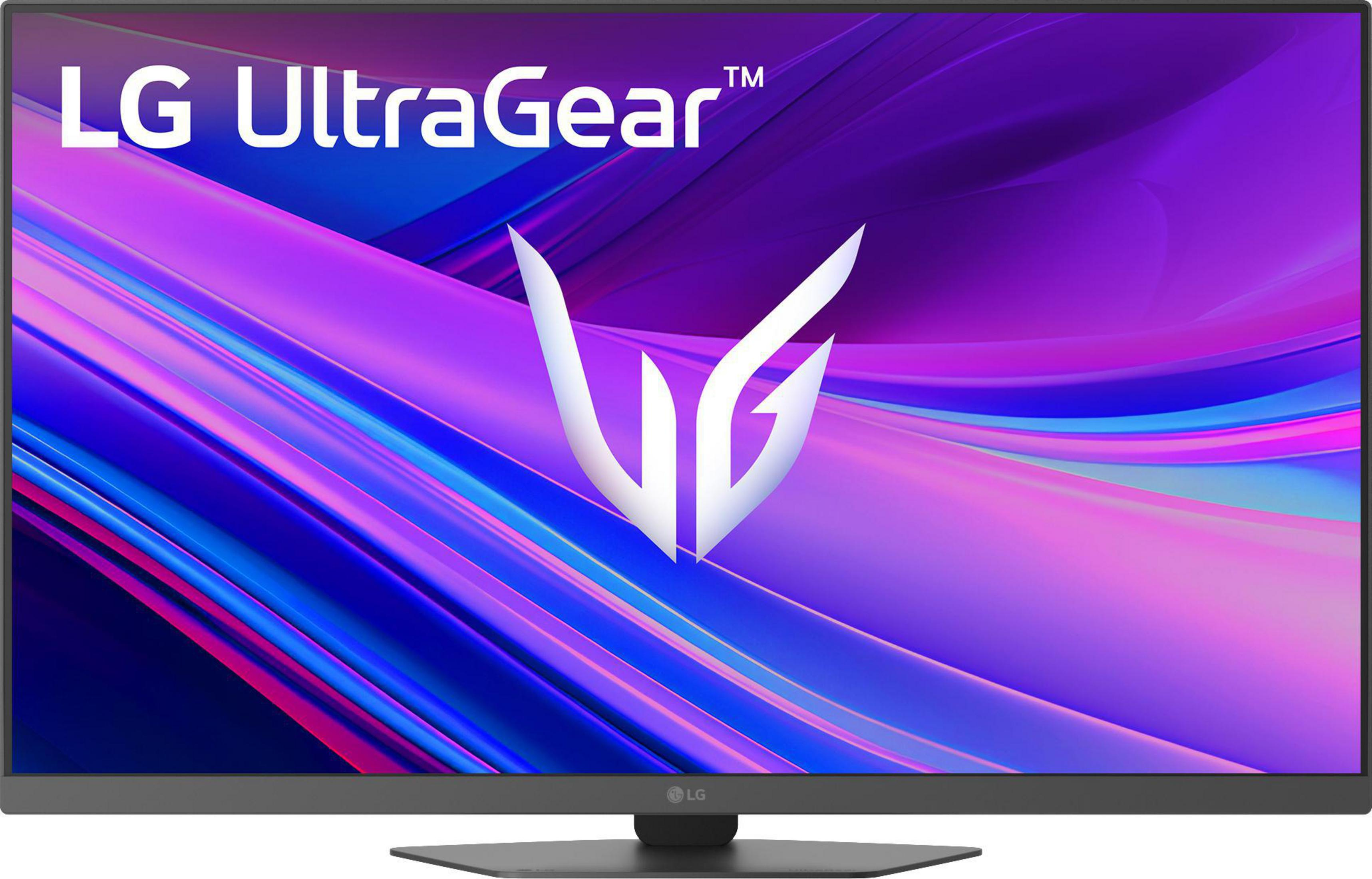 Monitor LG UltraGear z abstrakcyjnym, falistym tłem fioletowo-niebieskim.