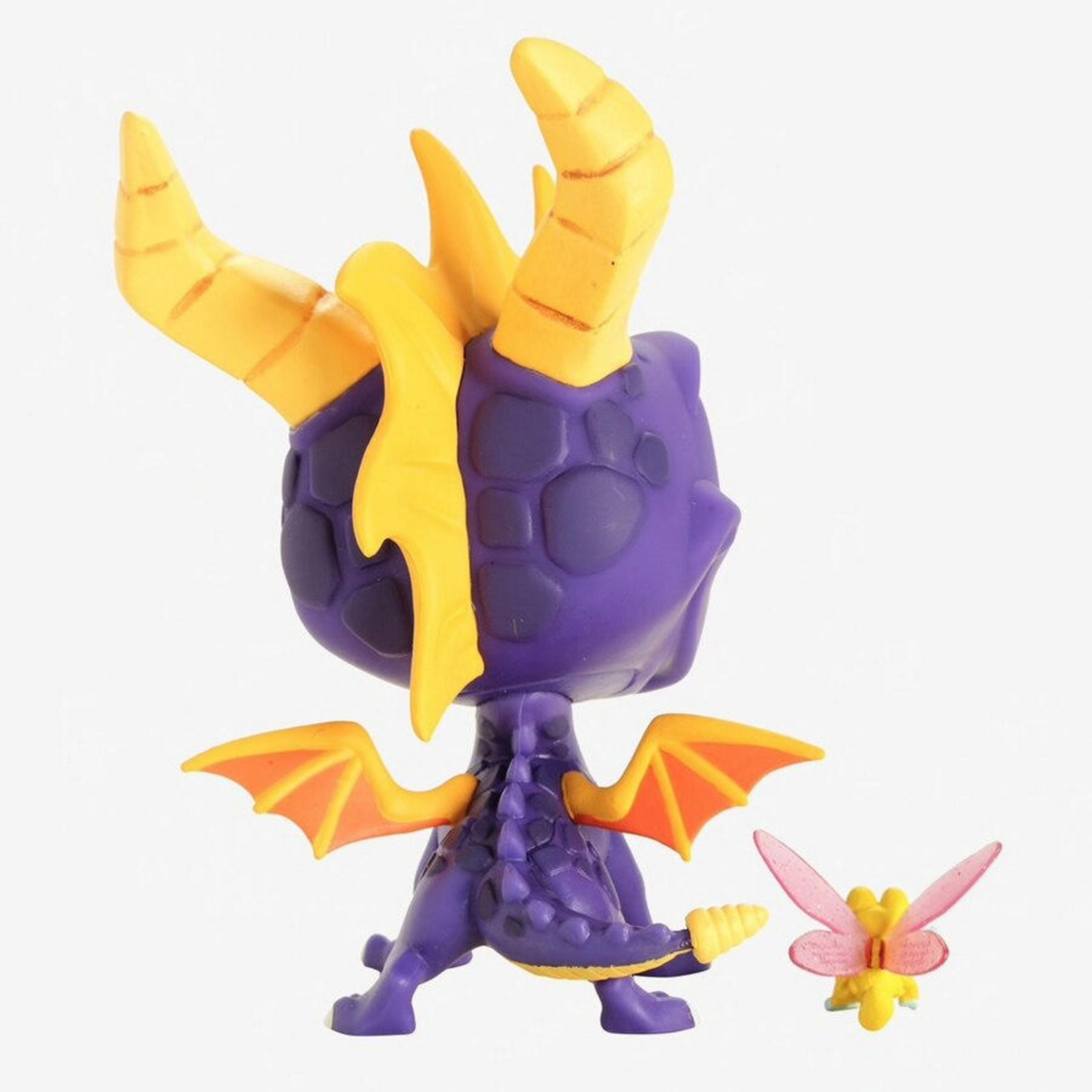 Lila Drachenfigur mit gelben Hörnern und Flügeln, daneben eine kleine gelbe Fee mit rosa Flügeln.