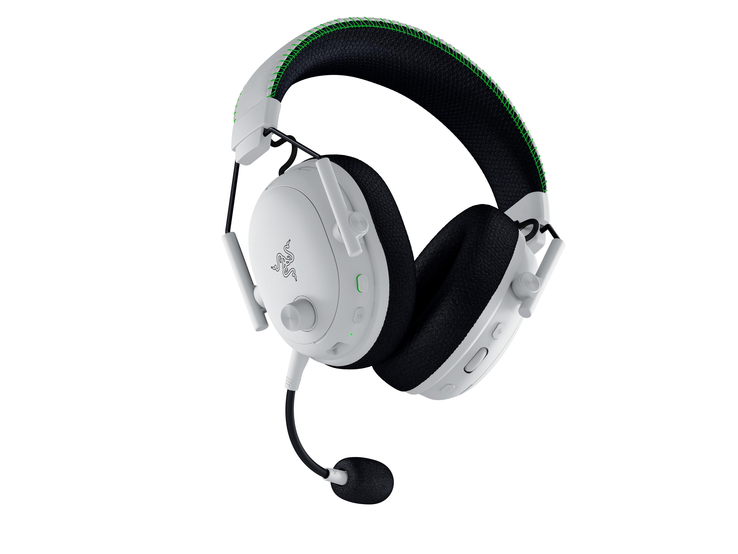 Cuffie da gaming bianche con archetto nero e cuciture verdi.