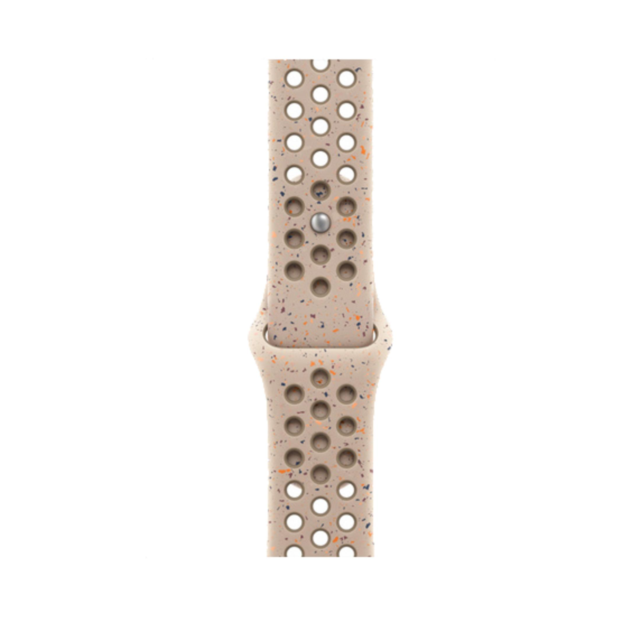 Hellbraunes Armband mit Perforation und Farbspritzern, mit silbernem Stift.