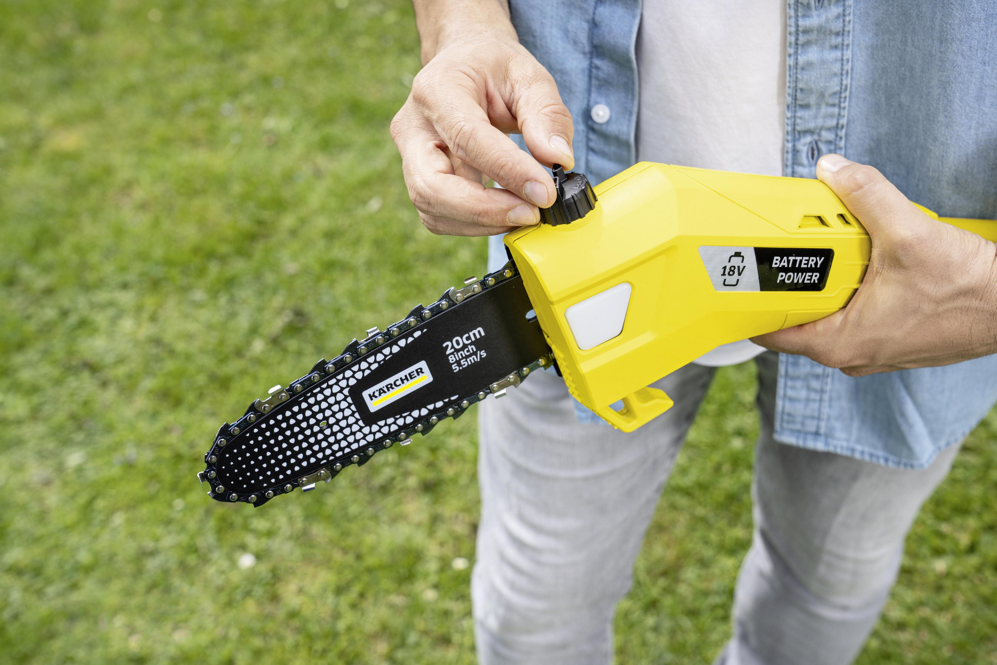 Eine Person hält eine gelbe Kettensäge mit 20cm/8Zoll Klinge im Freien.