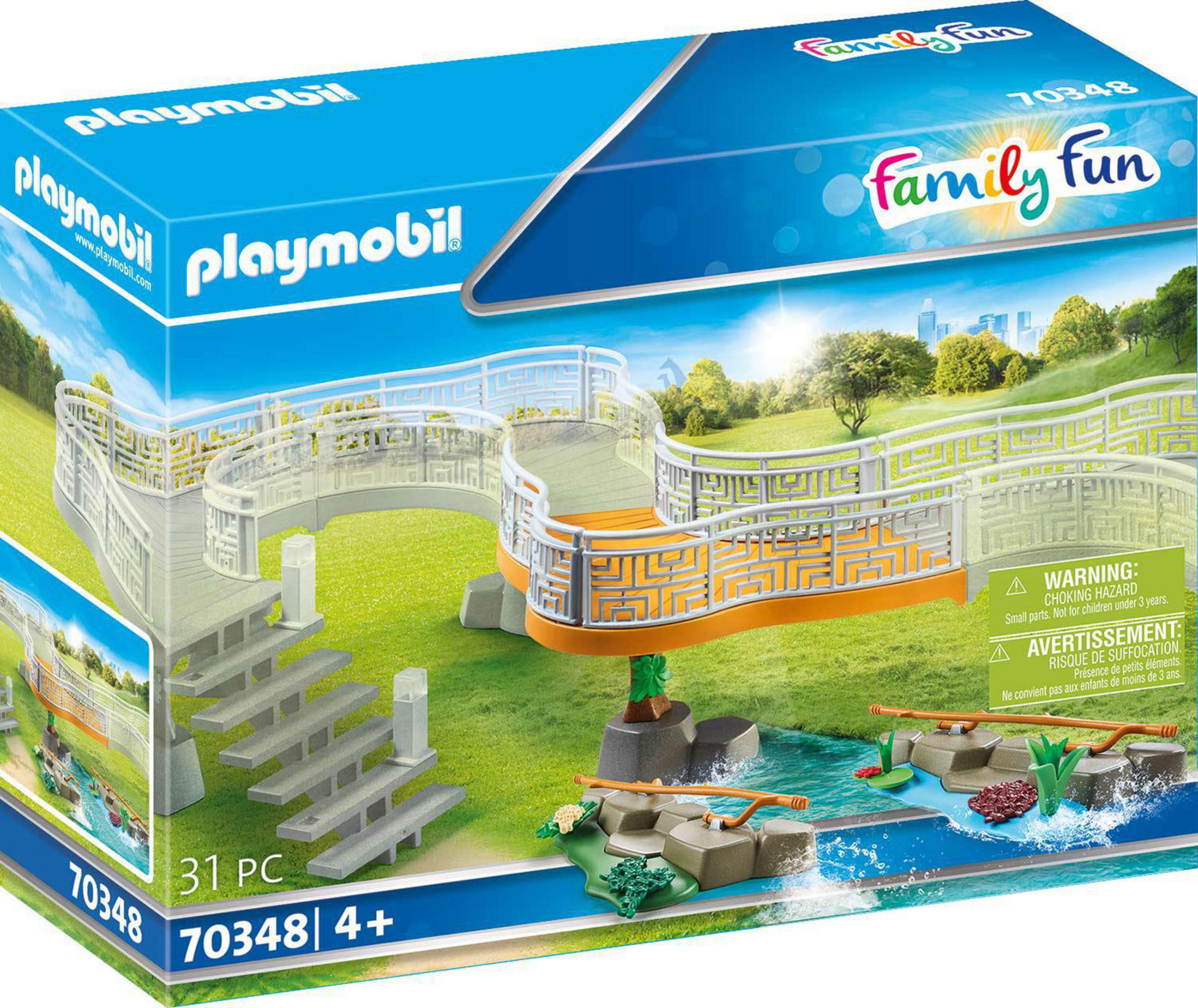 Scatola giocattoli Playmobil con un ponte su un ruscello ed etichette di avvertenza.