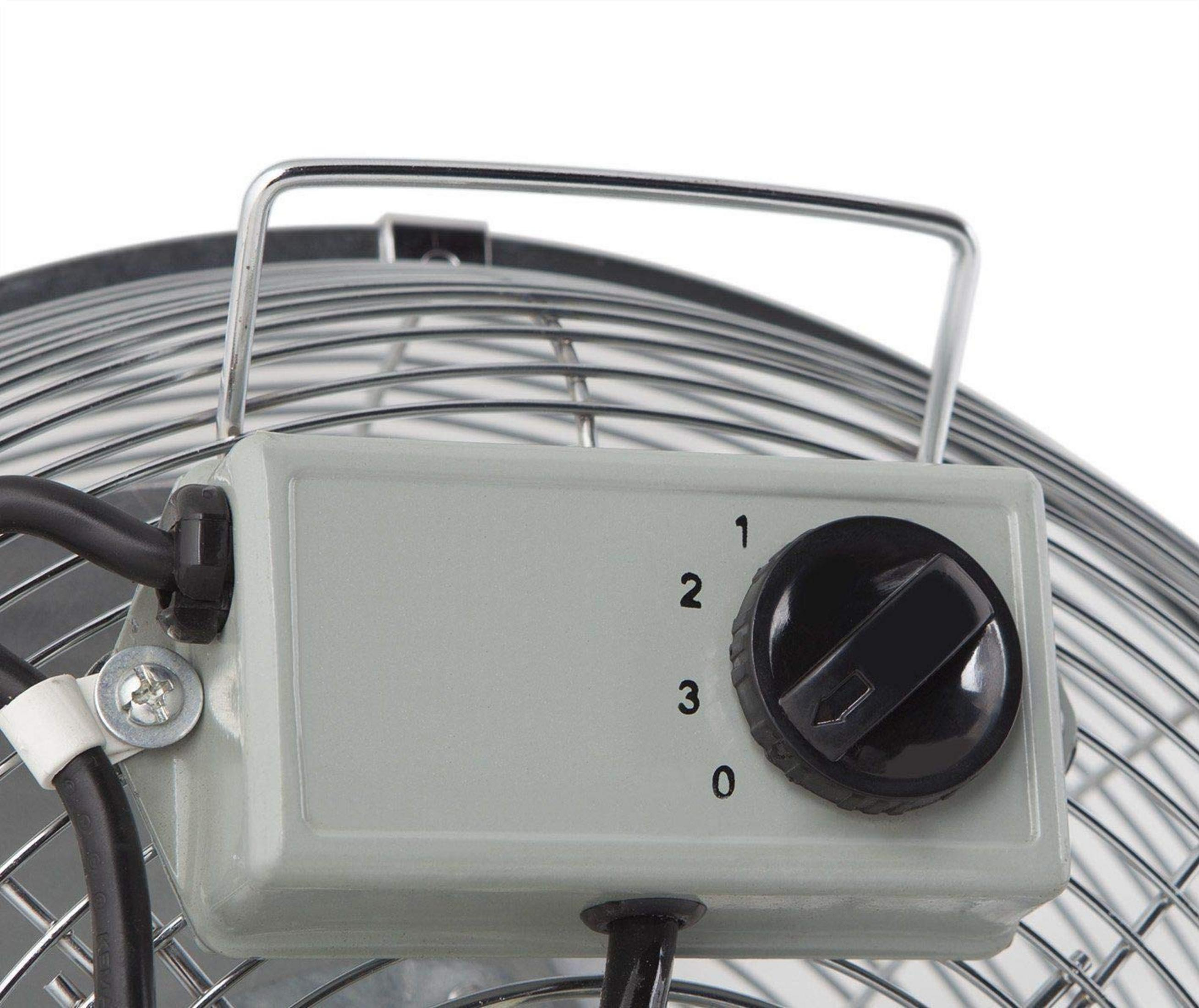 Un ventilador gris con un dial negro para control de velocidad (0-3).