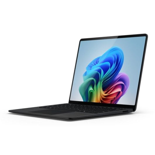 Czarny laptop wyświetlający kolorowy, abstrakcyjny obraz na ekranie.