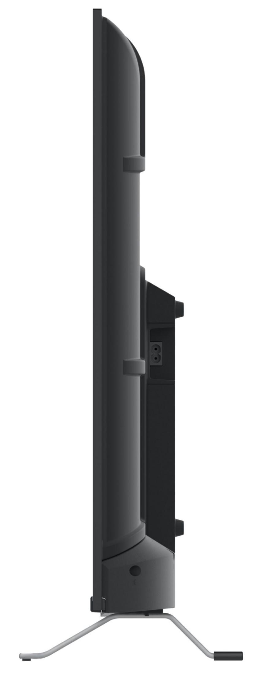 Televisor negro con soporte, vista lateral mostrando puertos.