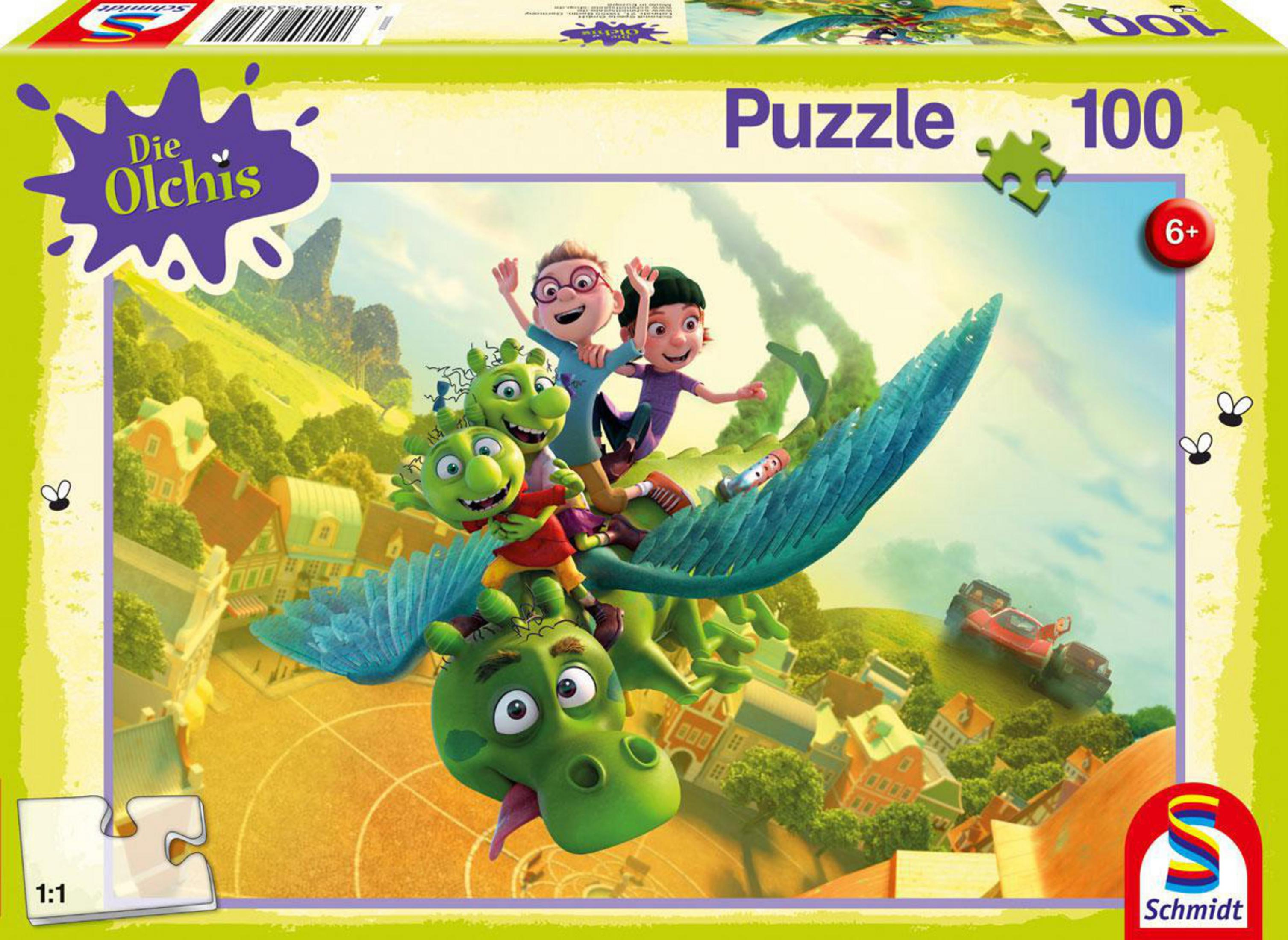 Grüner Drache fliegt mit Kindern über eine Stadt. Puzzle-Box.
