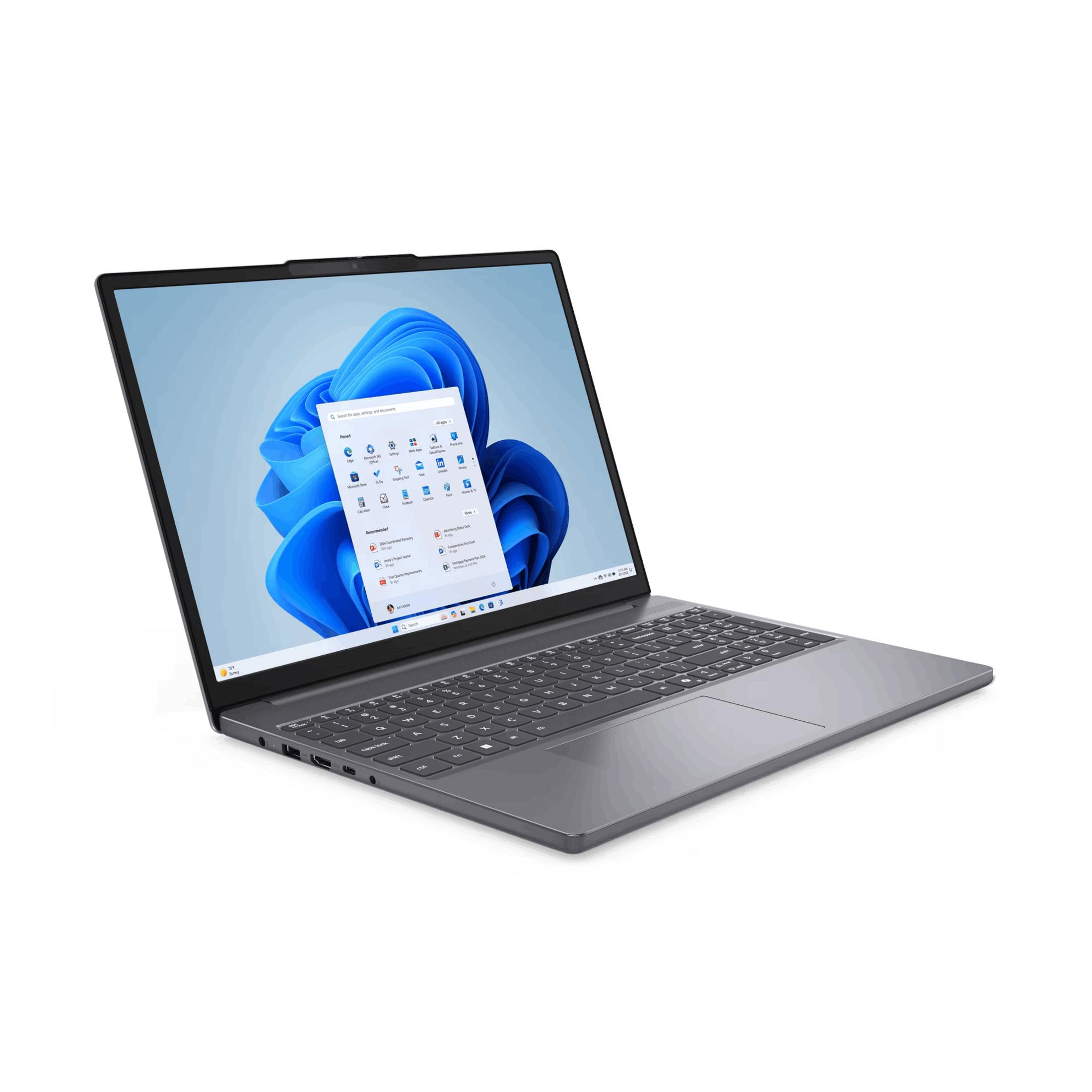 Portátil gris con pantalla de inicio de Windows 11, teclado y touchpad.