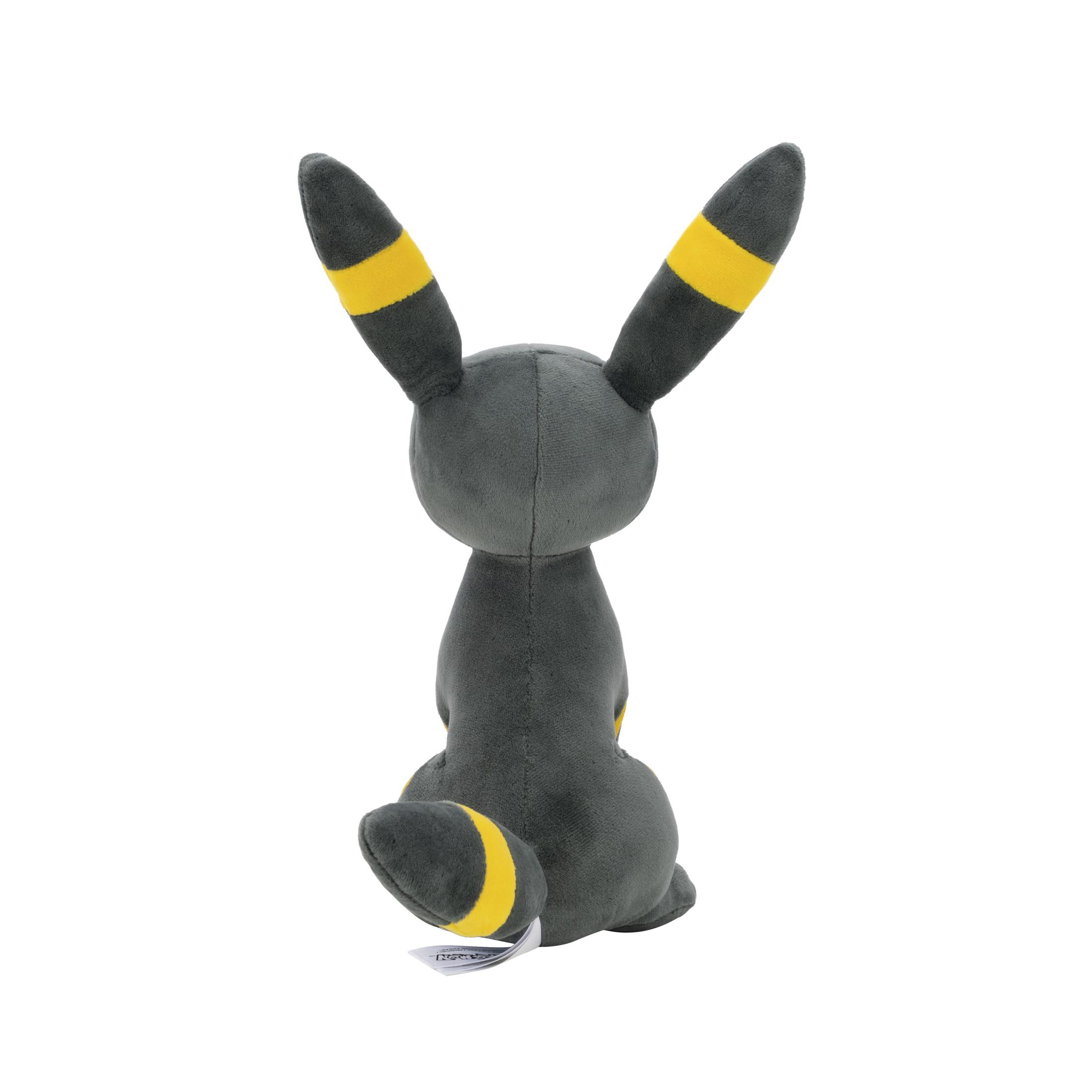 Une peluche grise avec des rayures jaunes sur les oreilles et la queue.