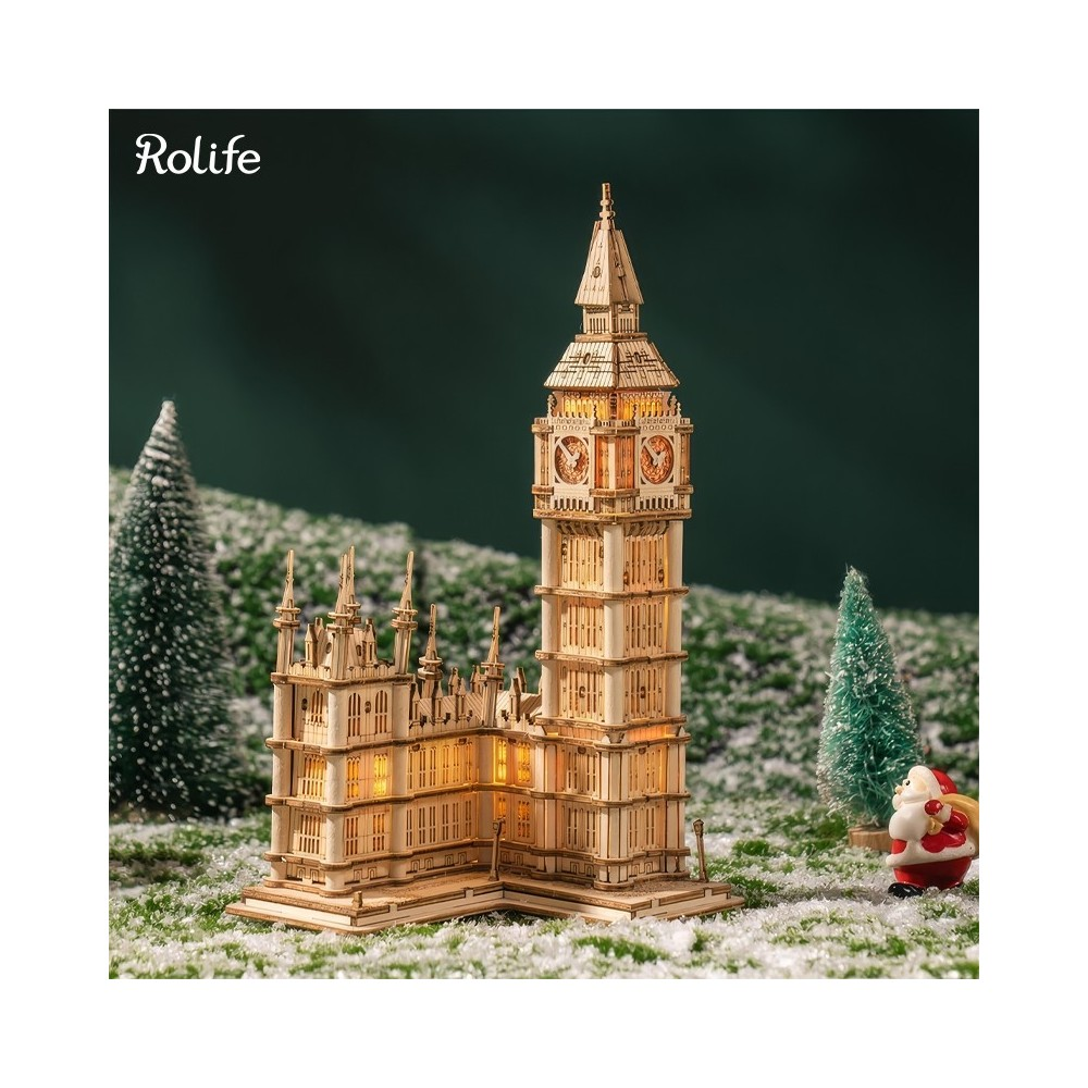 Karda ağaçlar ve Noel Baba ile ahşap Big Ben modeli.