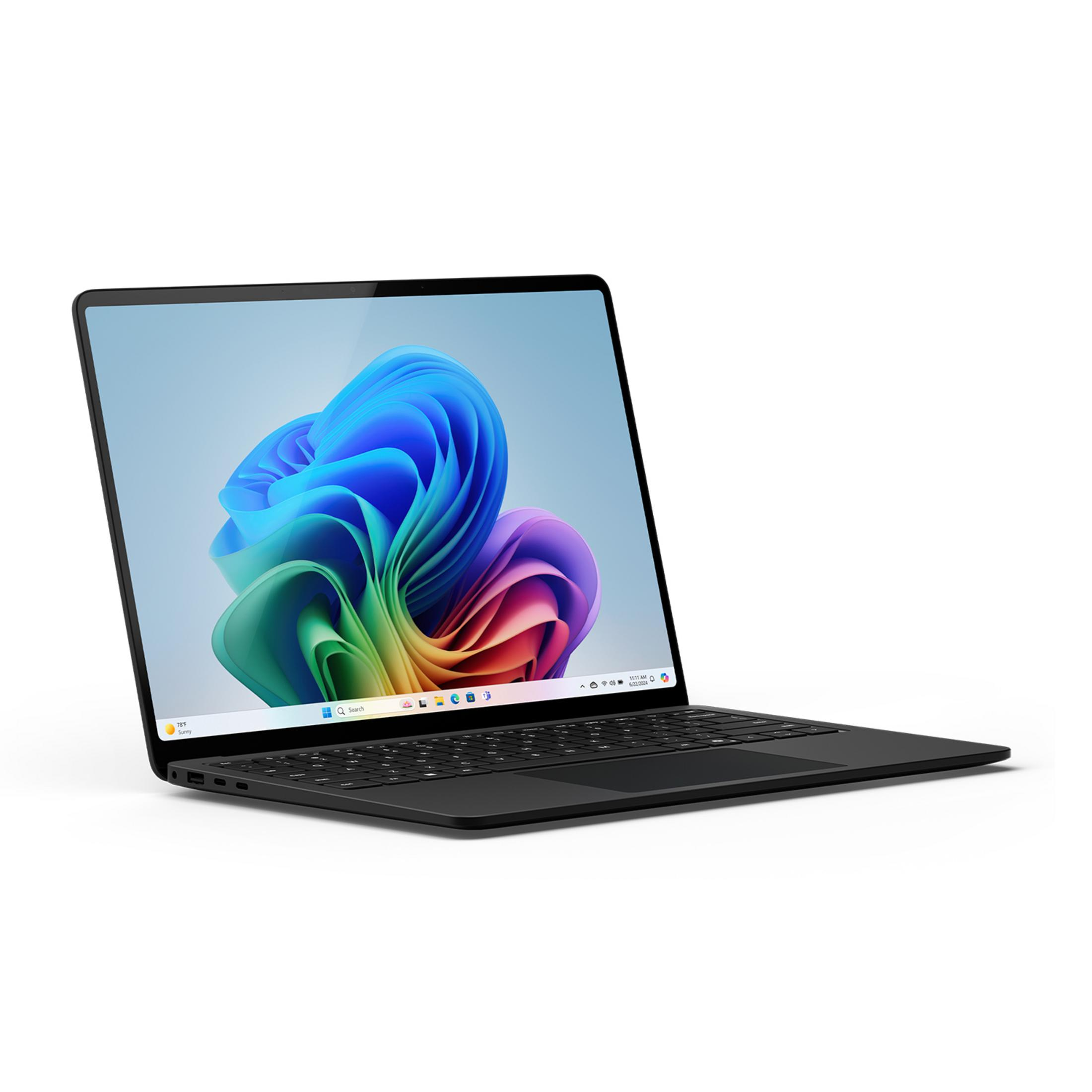 Czarny laptop z kolorową abstrakcyjną tapetą na ekranie.