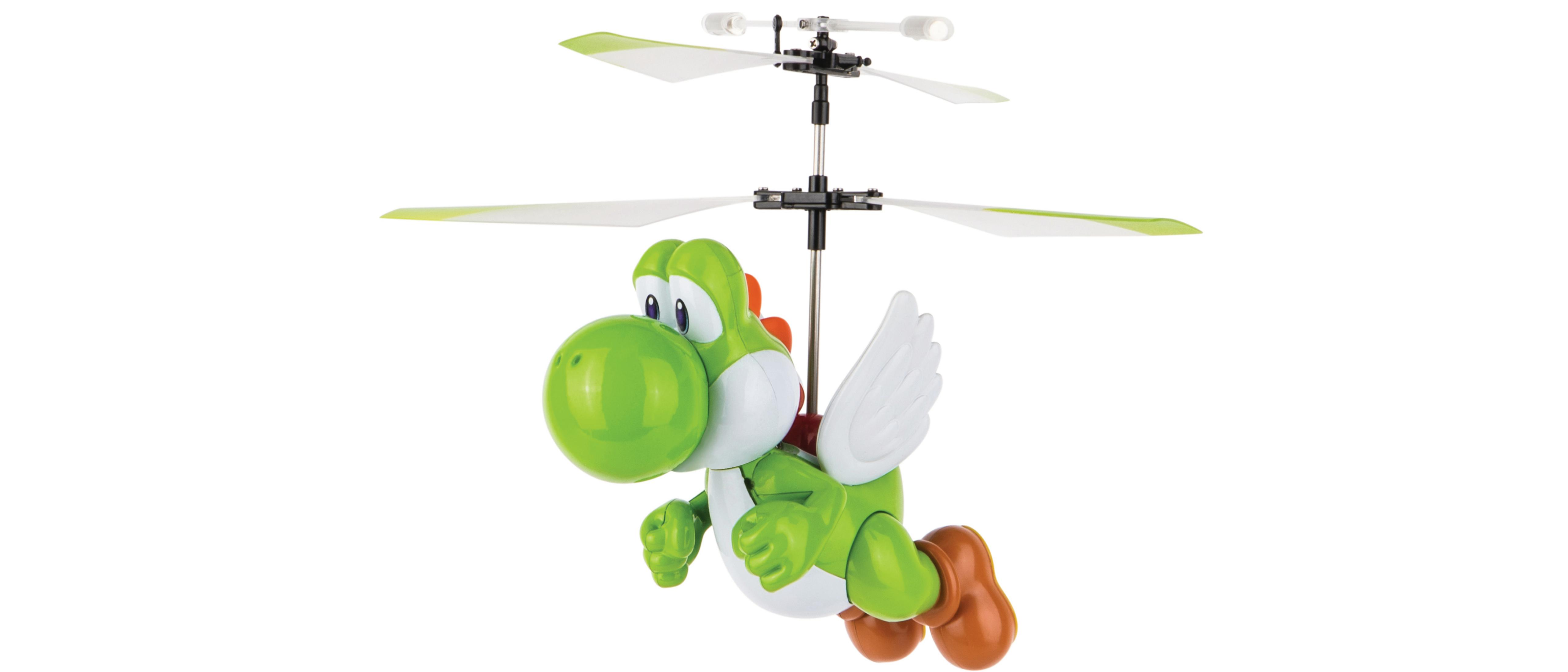 Eine grüne Yoshi-Drohne mit Flügeln fliegt vor weißem Hintergrund.