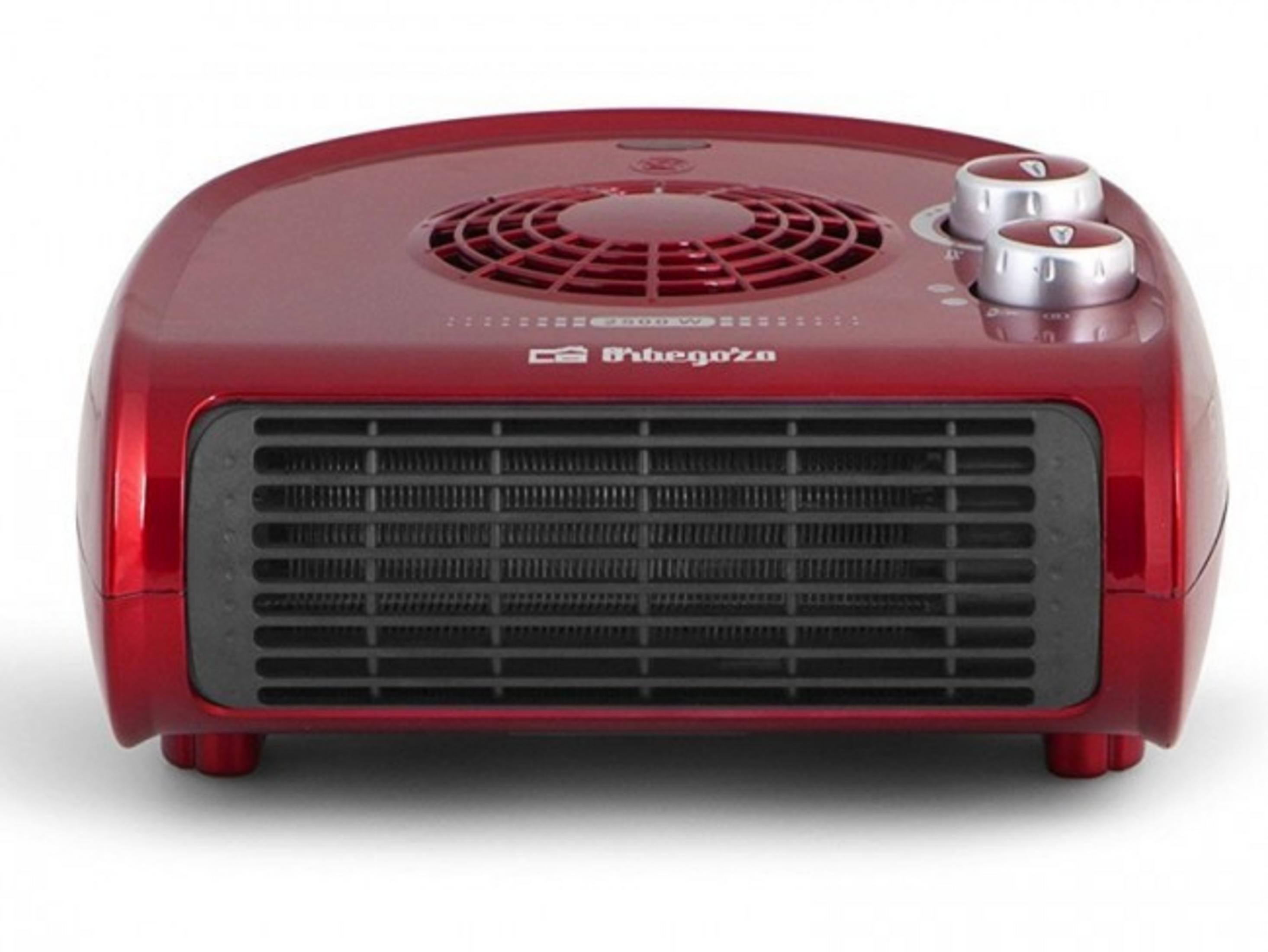 Una stufetta a ventola rossa con griglia di ventilazione e due manopole.