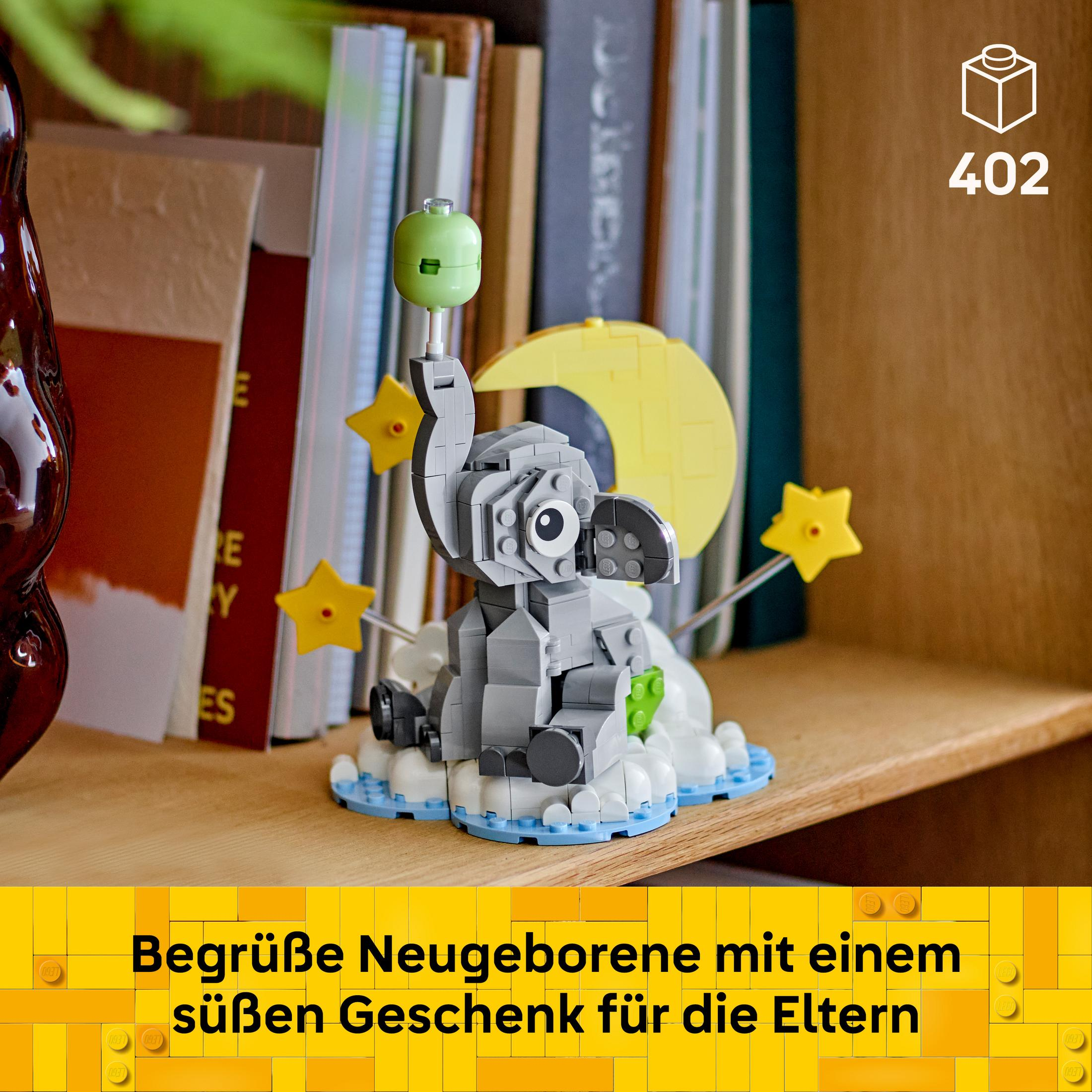 Un elefante Lego siede su nuvole con stelle e luna. Libri sullo sfondo.