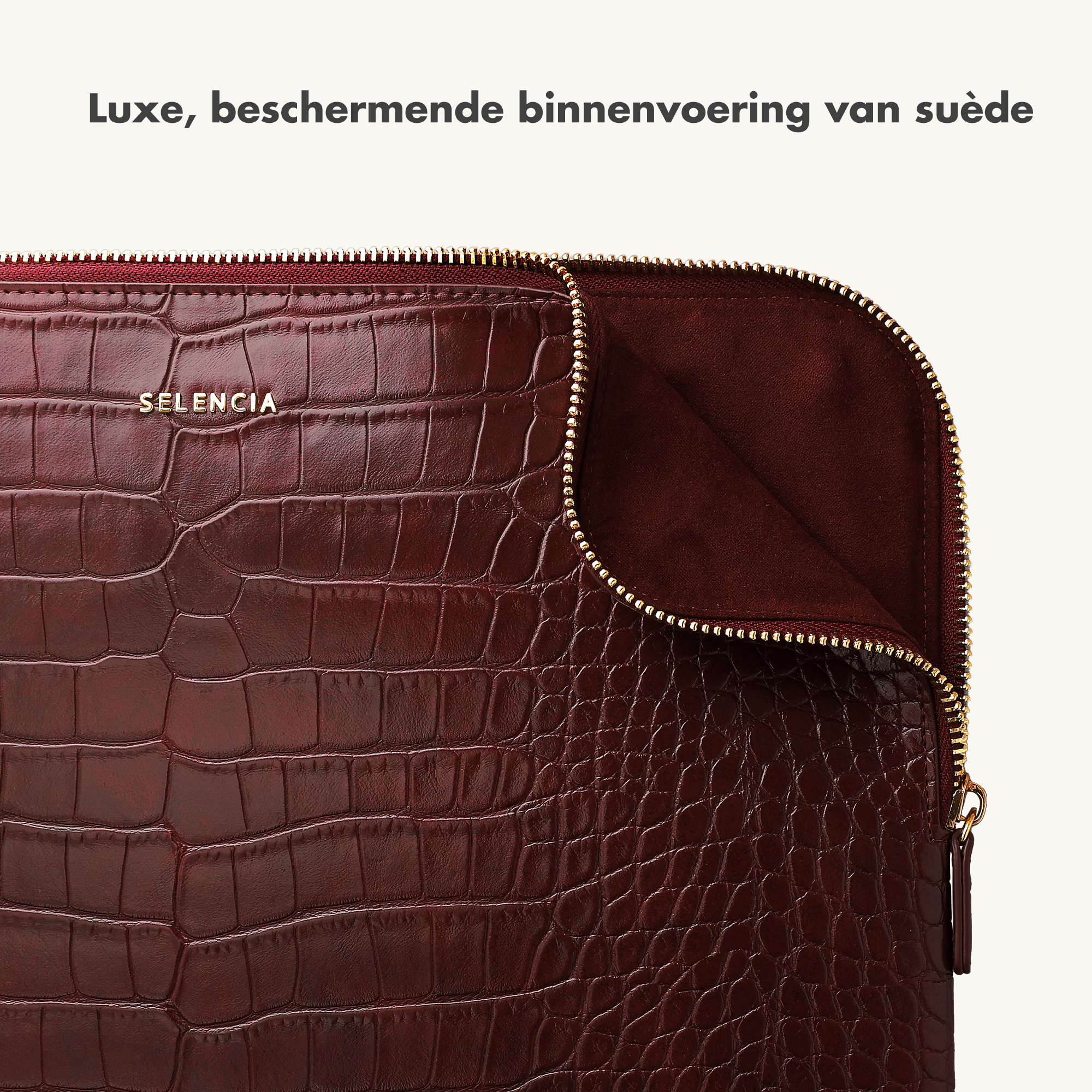 Dunkelrotes Krokodilleder-Etui mit goldfarbenem Reißverschluss und Logo.
