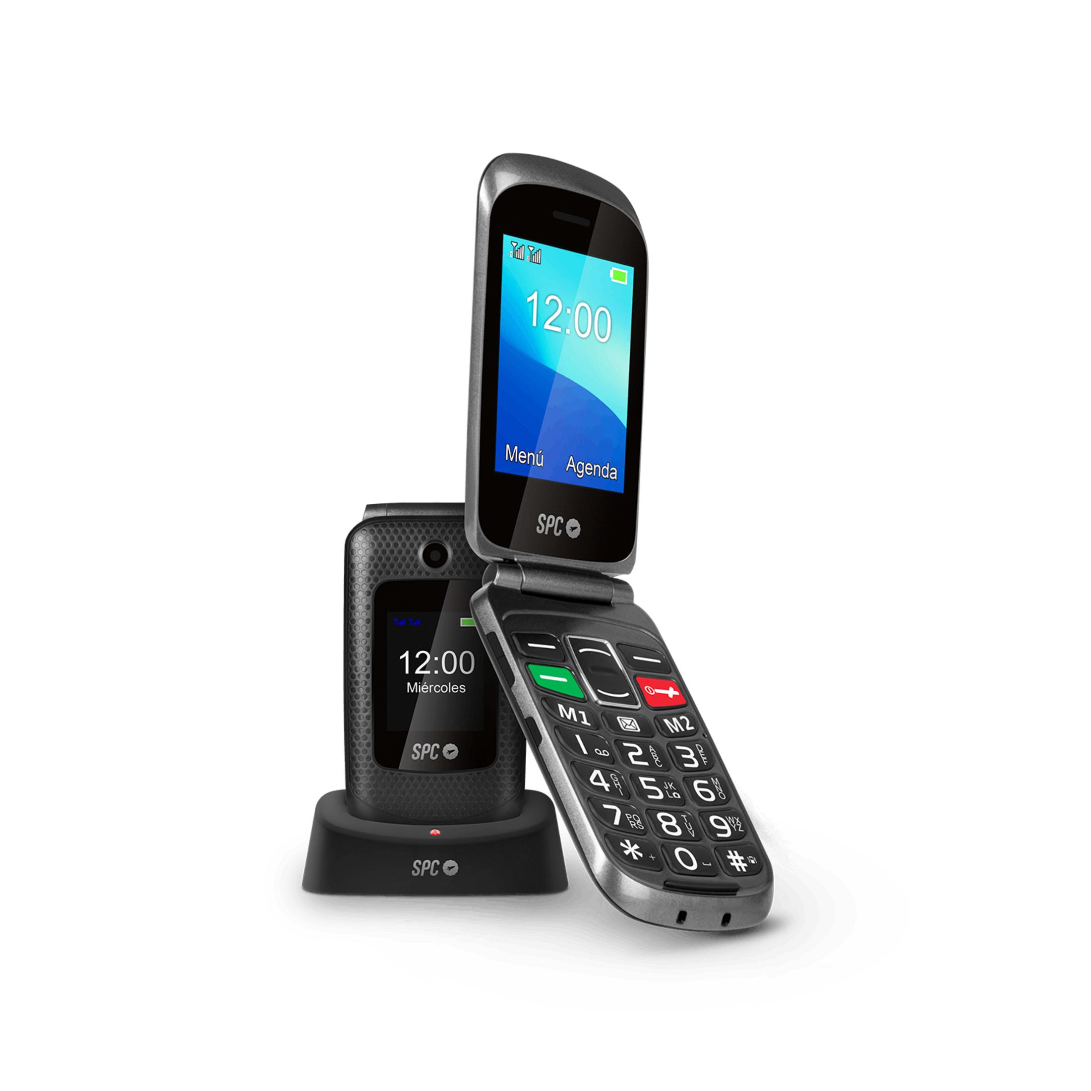 Un telefono a conchiglia nero con base di ricarica. Il telefono è aperto e mostra l'ora.