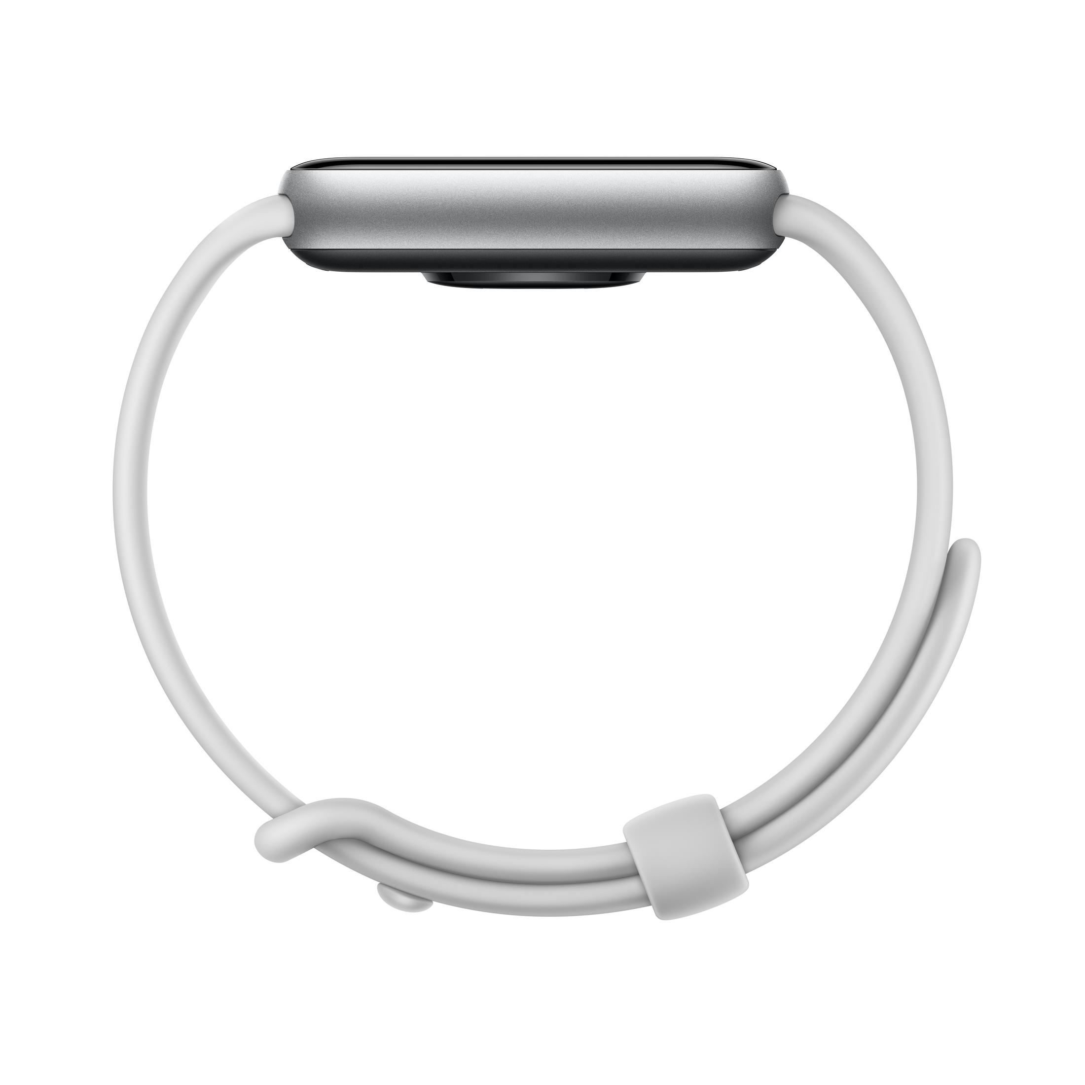Uno smartwatch argentato con cinturino bianco, visto di lato.