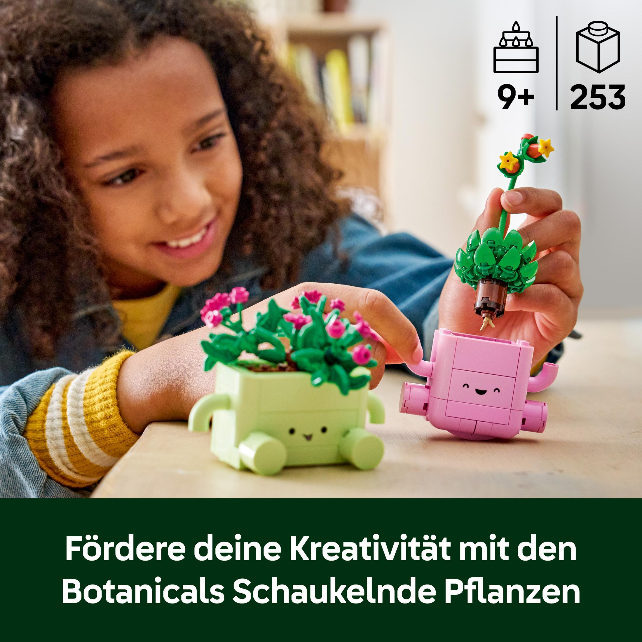 Bir kız Lego bitkileri yapıyor. Çiçekli yeşil saksı, bitkili pembe saksı.