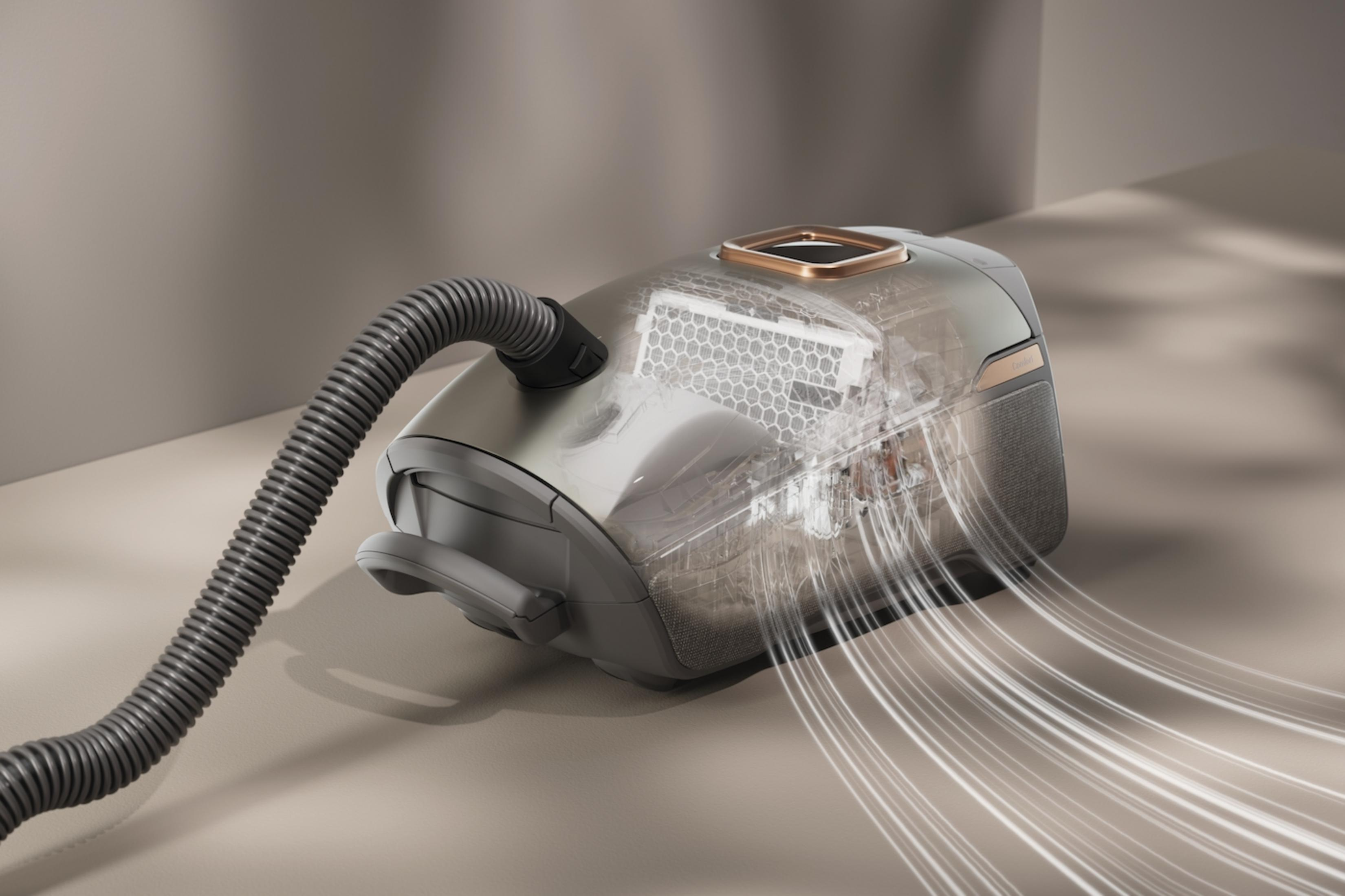 Un aspirapolvere trasparente con tubo grigio, che mostra filtro interno e flusso d'aria.