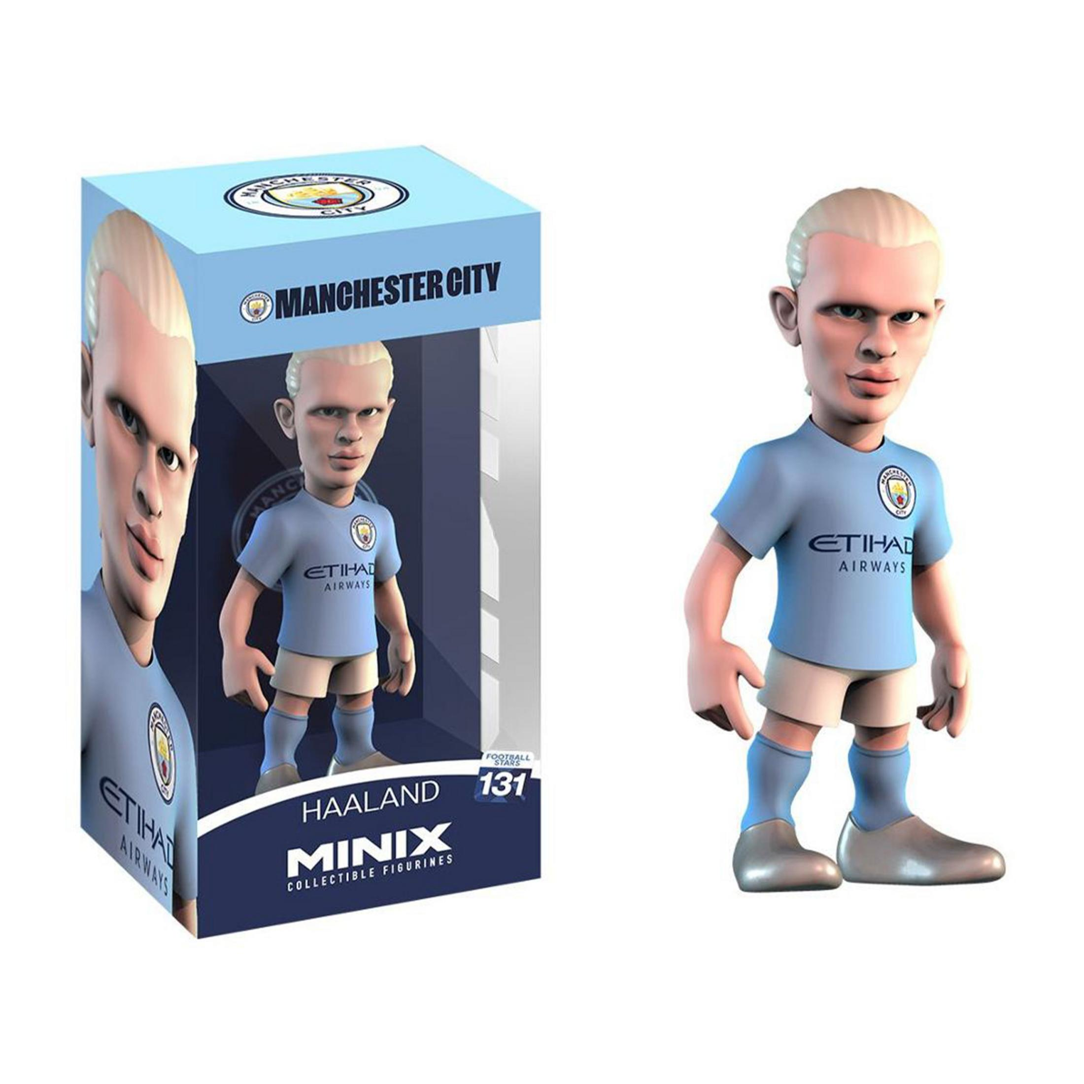 Una figura di Erling Haaland in stile cartone animato con la maglia del Manchester City accanto alla sua confezione.