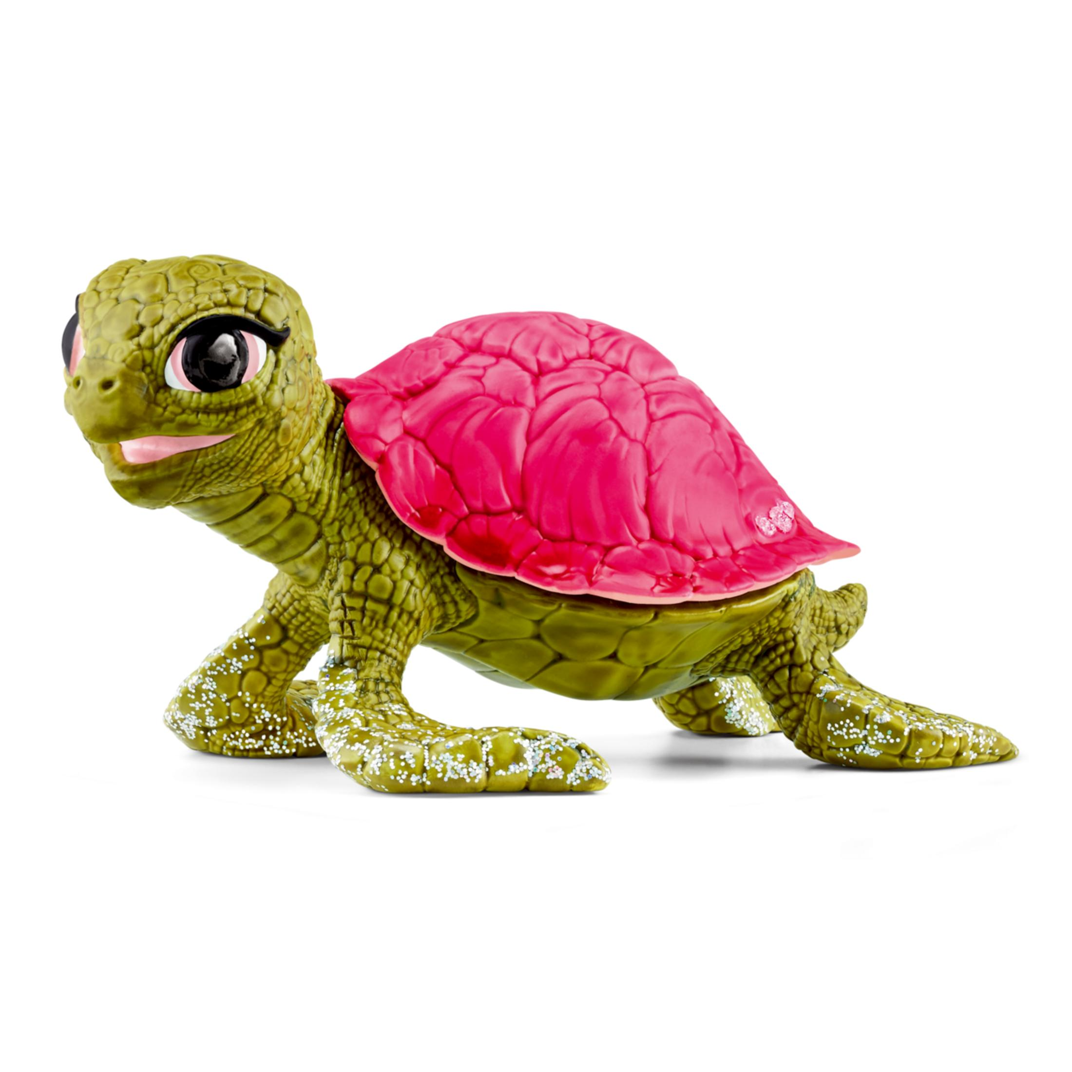 Una tartaruga giocattolo verde con guscio rosa brillante e glitter sulle zampe.