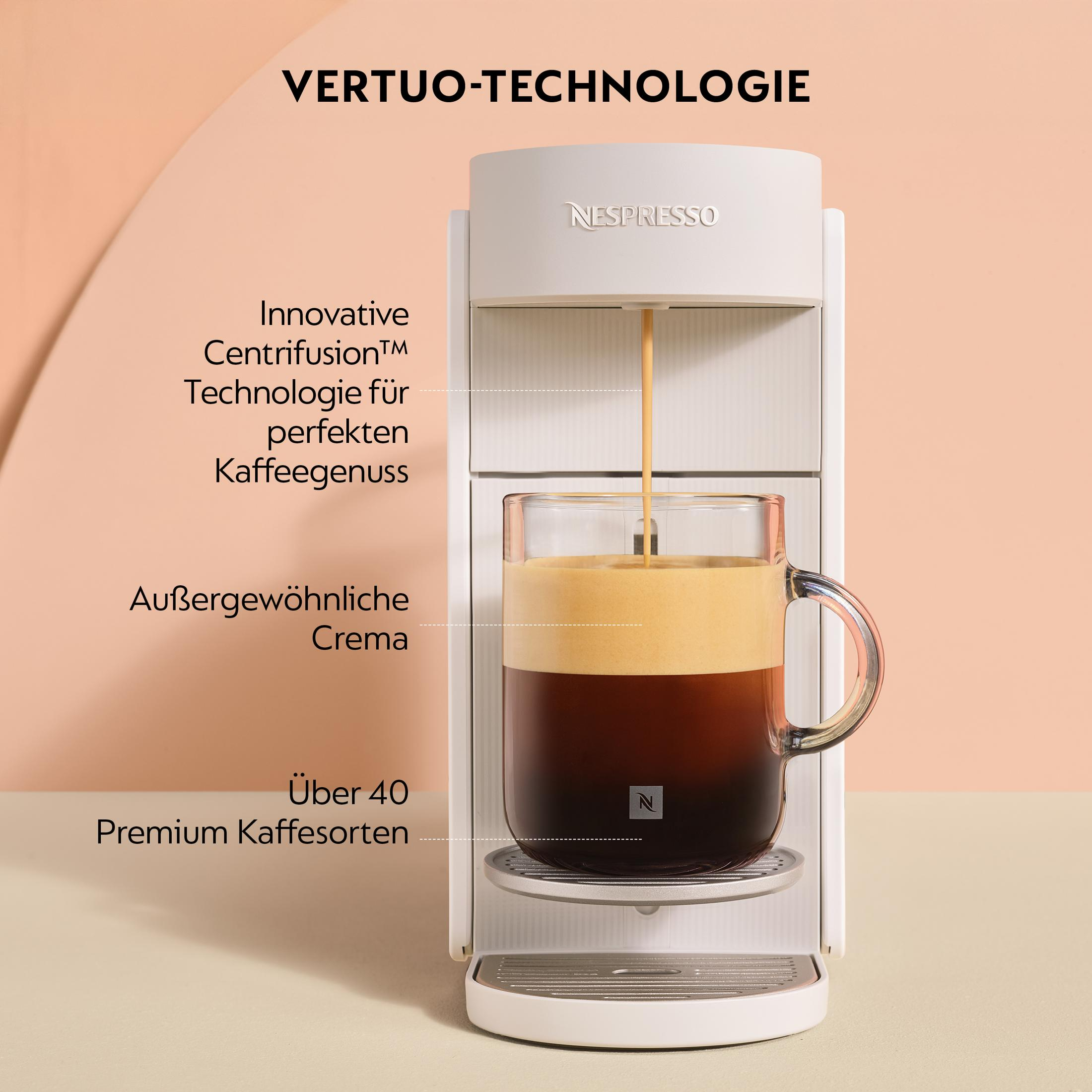 Weiße Nespresso Vertuo Kaffeemaschine brüht Kaffee in ein Glas mit Crema.