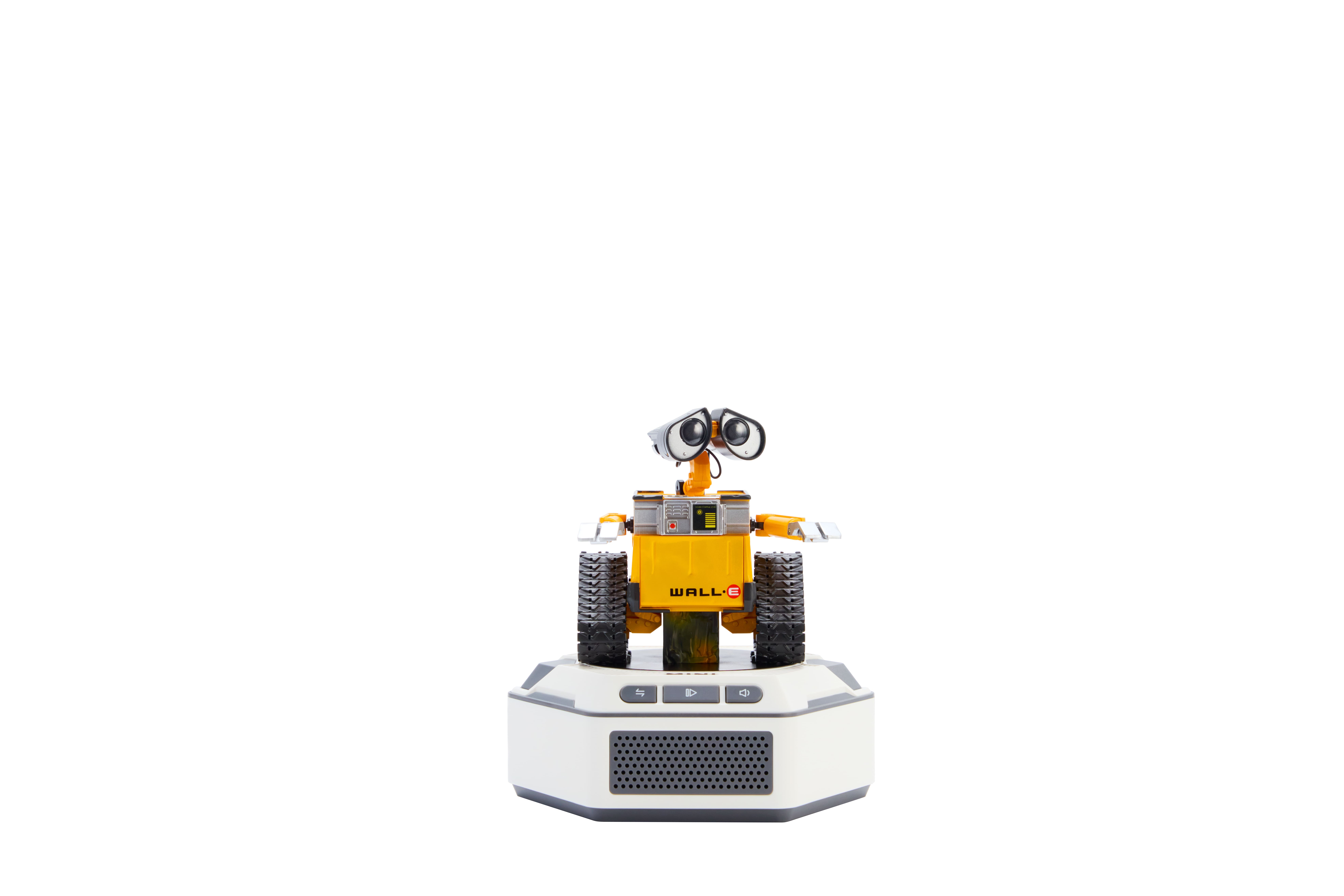 Un robot amarillo con ruedas de oruga sobre una base blanca.