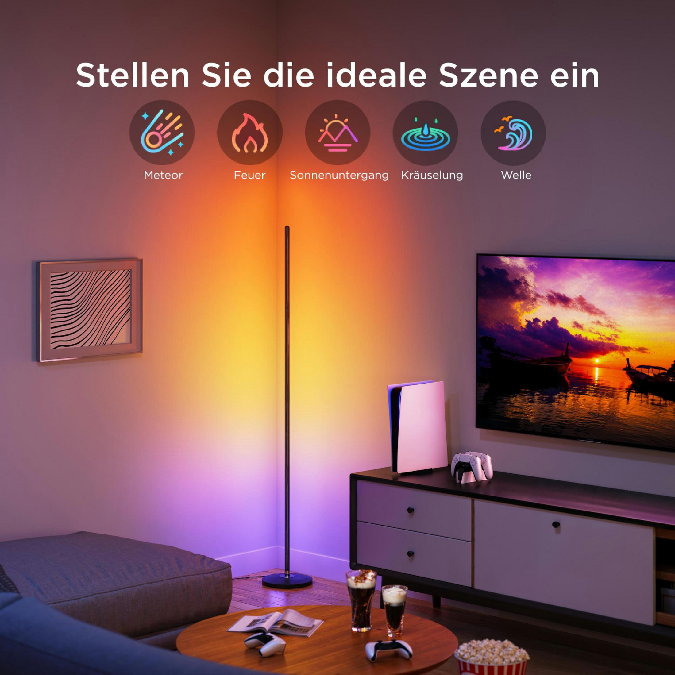 Salon z telewizorem pokazującym zachód słońca. Lampa podłogowa oświetla przestrzeń.
