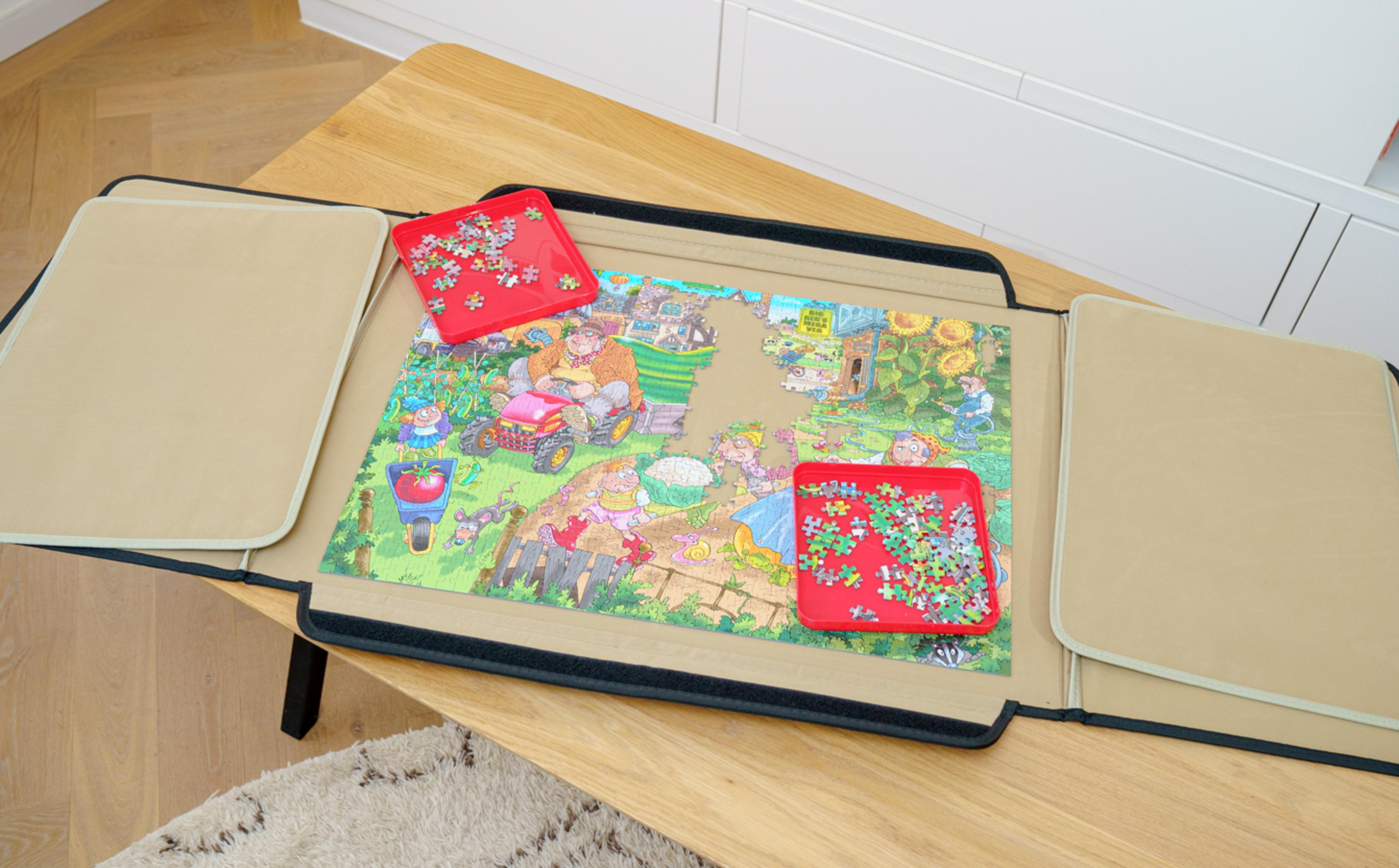A puzzle with a garden scene is on a mat, with red trays for puzzle pieces.