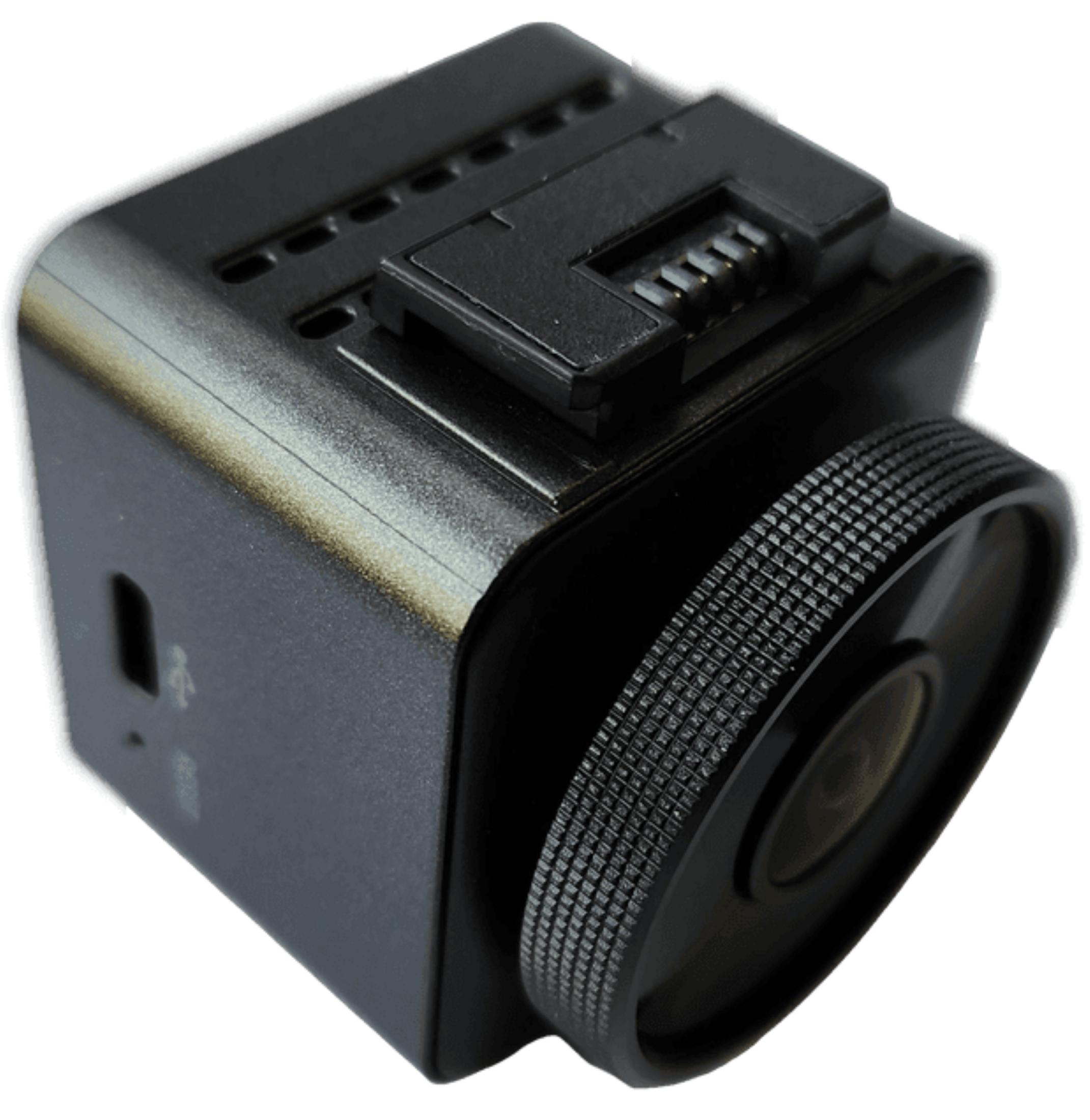 Kompakte schwarze Kamera mit gerändeltem Objektivring und USB-Anschluss.