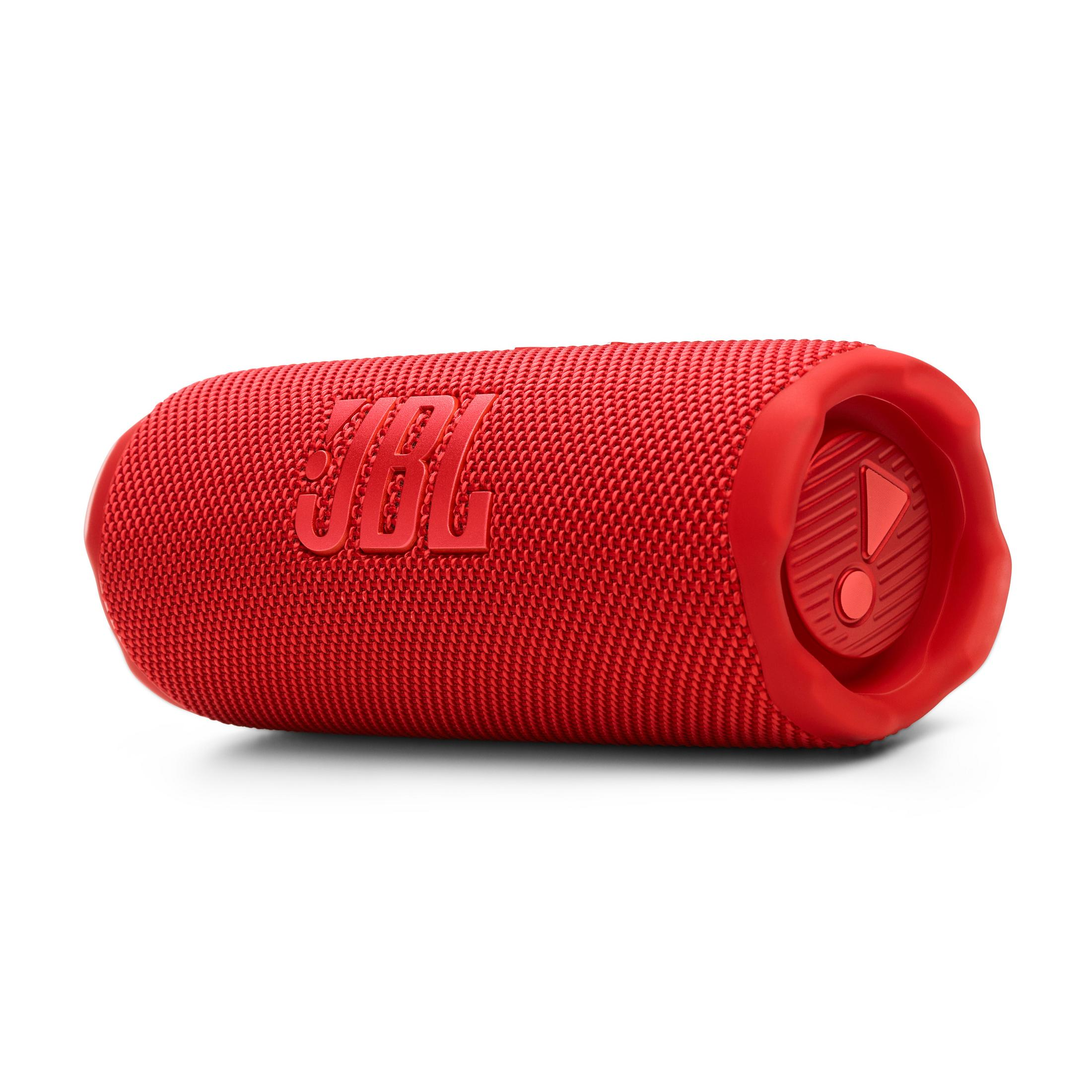 Un altoparlante JBL rosso con copertura in tessuto e logo. A destra un elemento di controllo rosso.