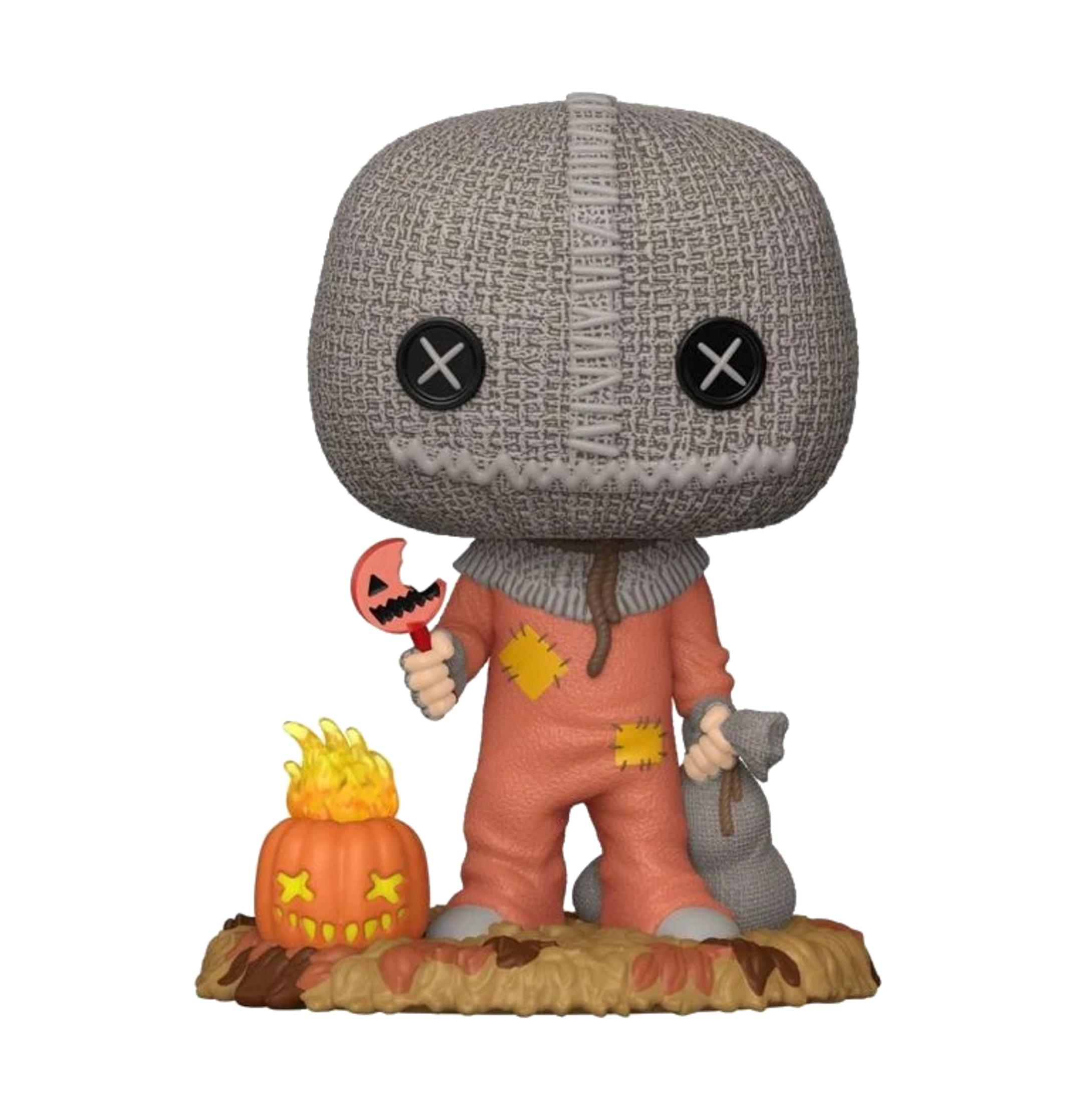 Sam tiene un lecca-lecca a forma di zucca e un sacco. Accanto a lui c'è una zucca con fiamme sulla testa.