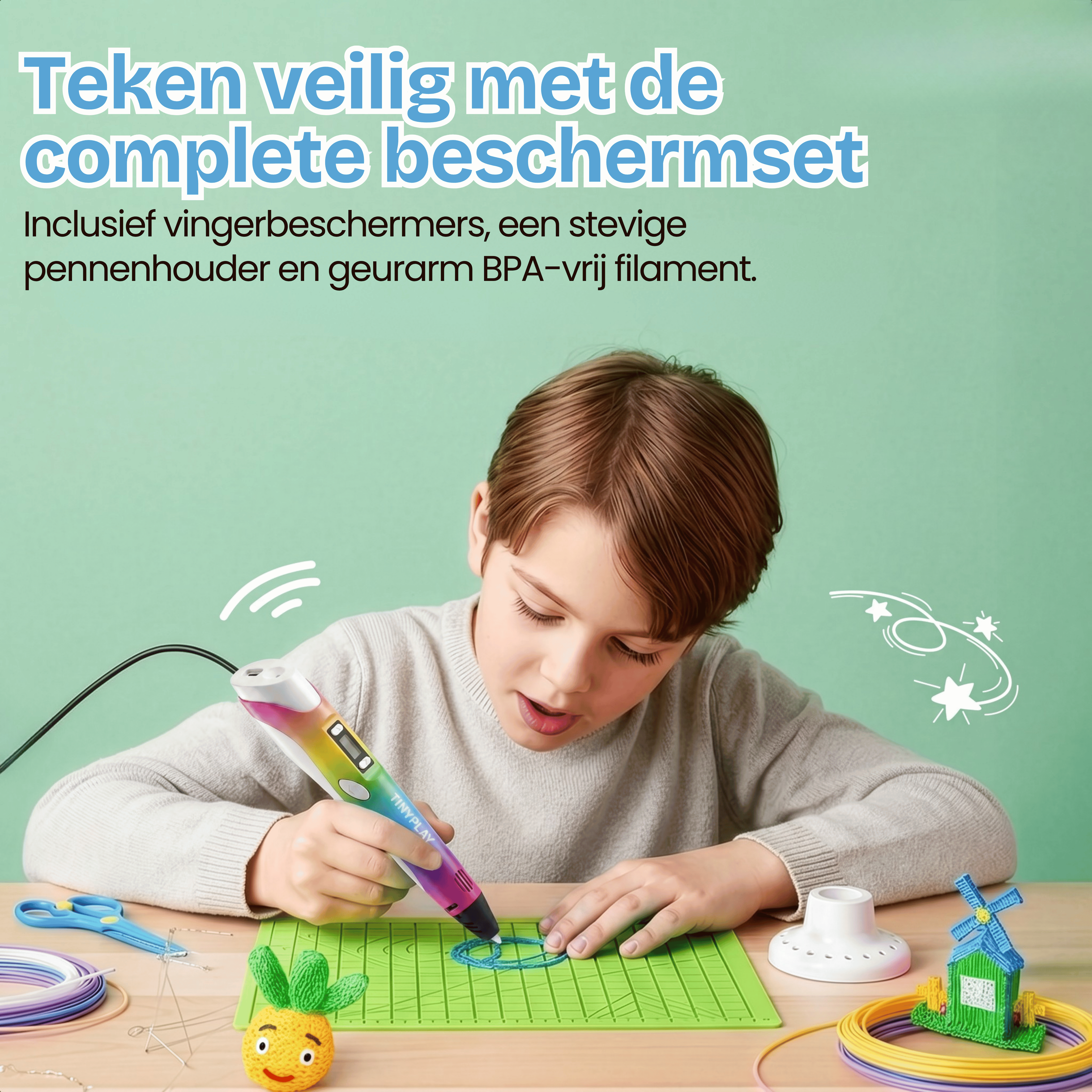 A boy uses a colorful 3D pen to draw on a green mat, with craft supplies around.