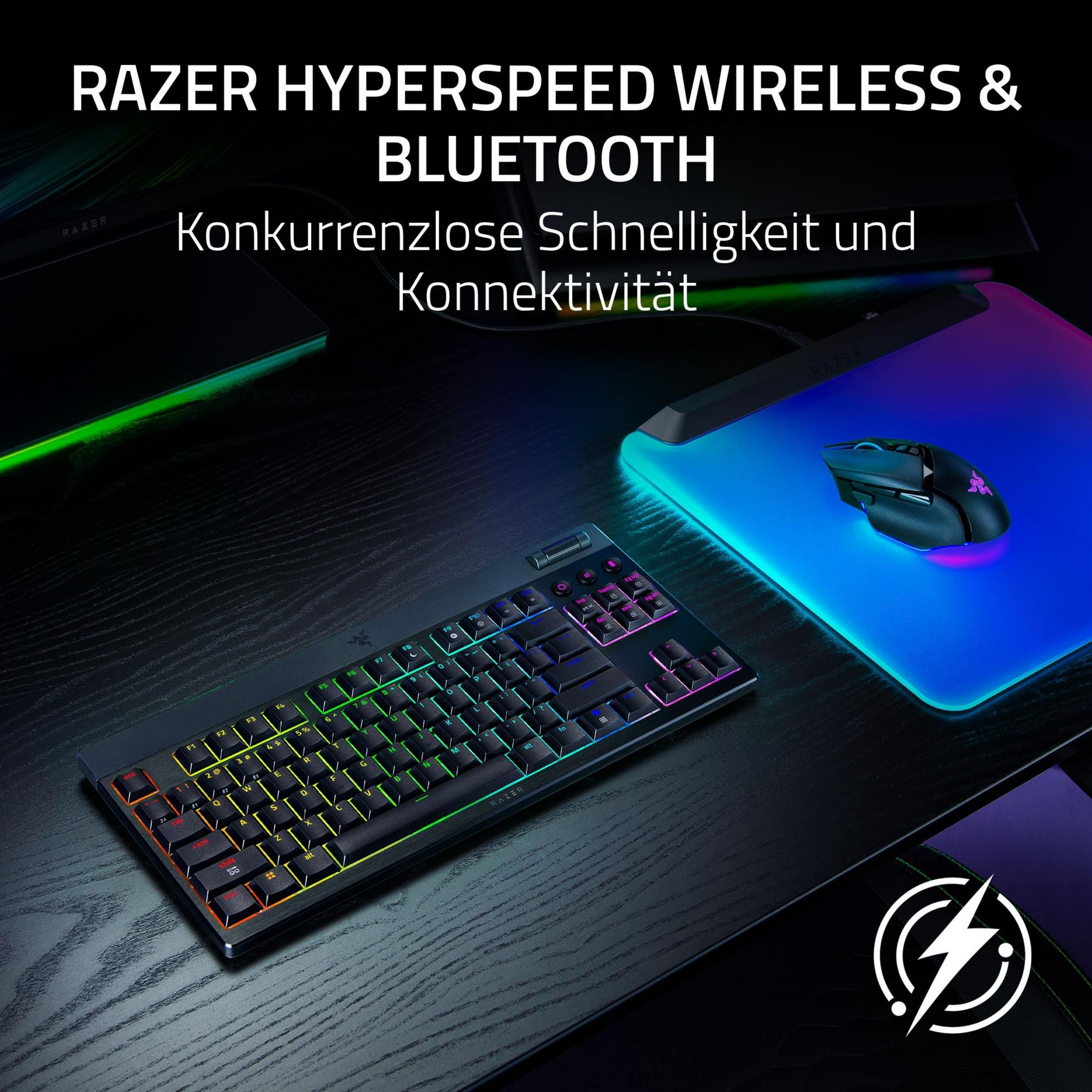 Razer Tastatur und Maus mit RGB-Beleuchtung auf schwarzem Holztisch.