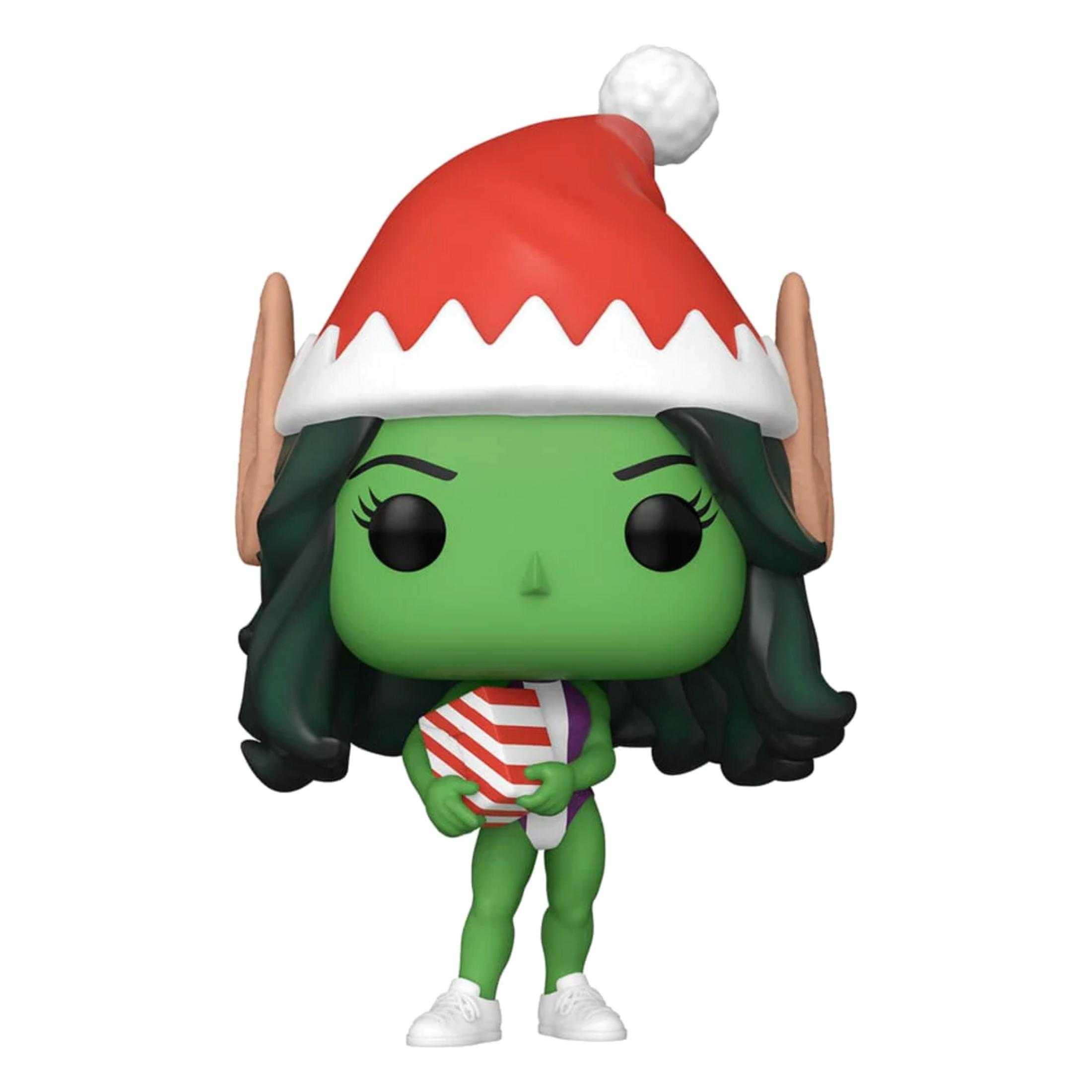 Figura verde con gorro de Santa sostiene un regalo.