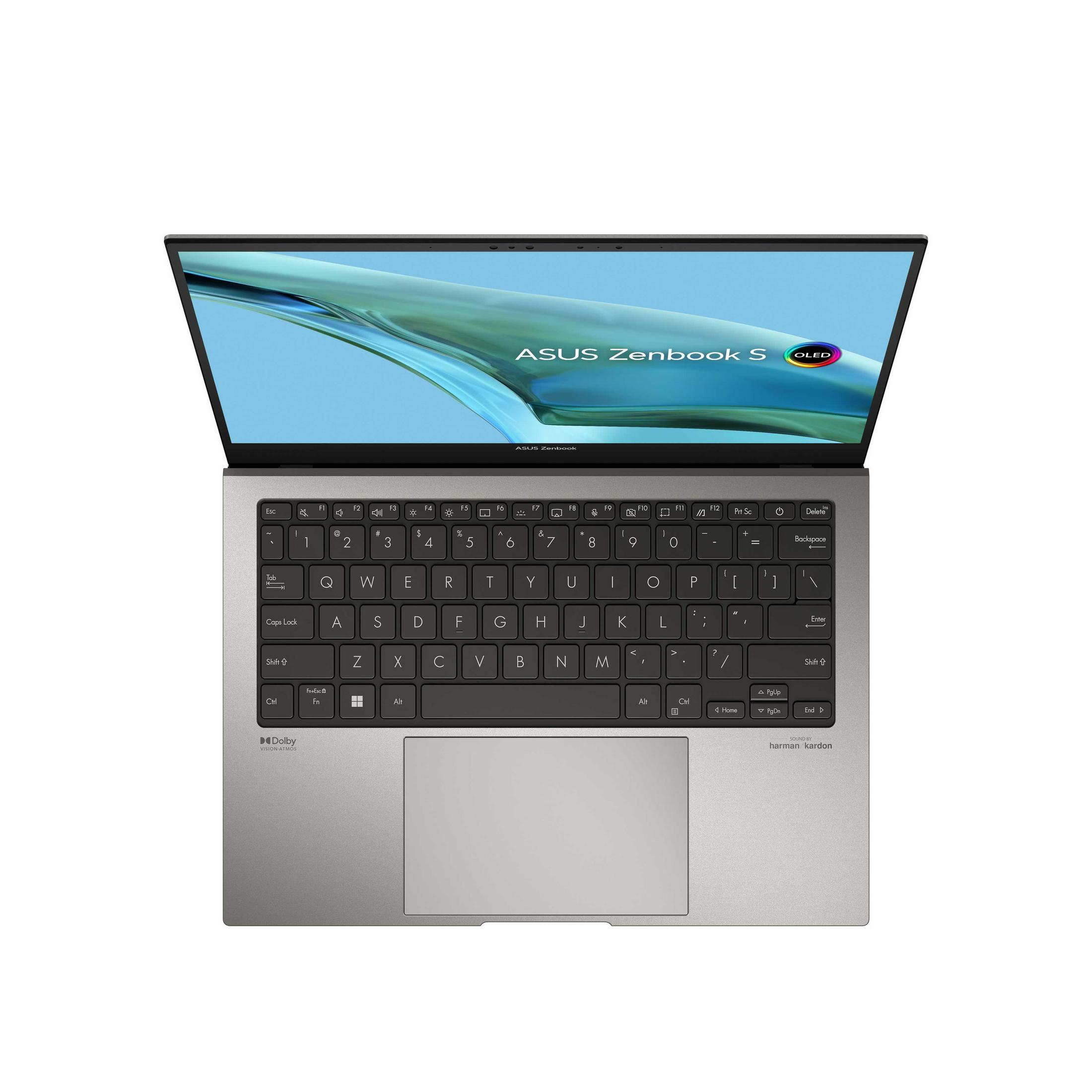 Un portátil plateado Asus Zenbook S con pantalla OLED, abierto sobre una superficie blanca.